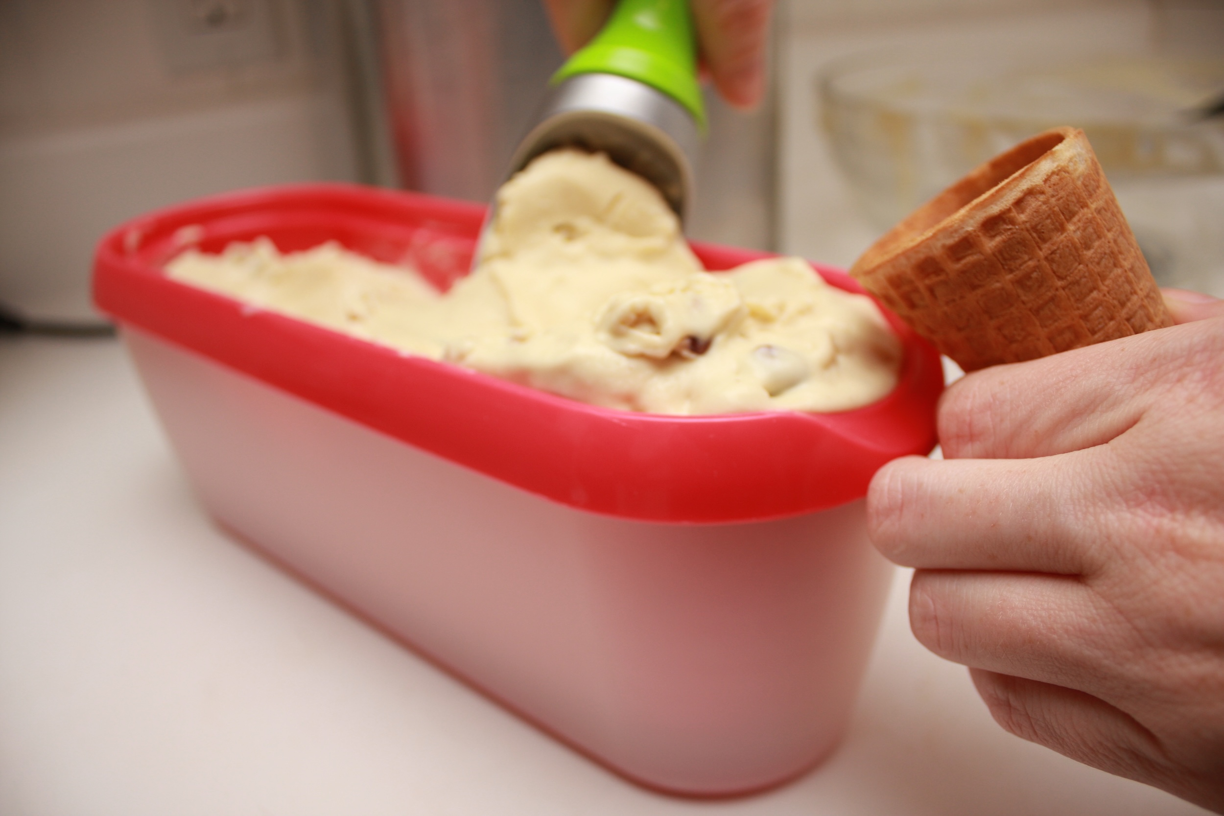 Alyssa scoops ice cream into a cone