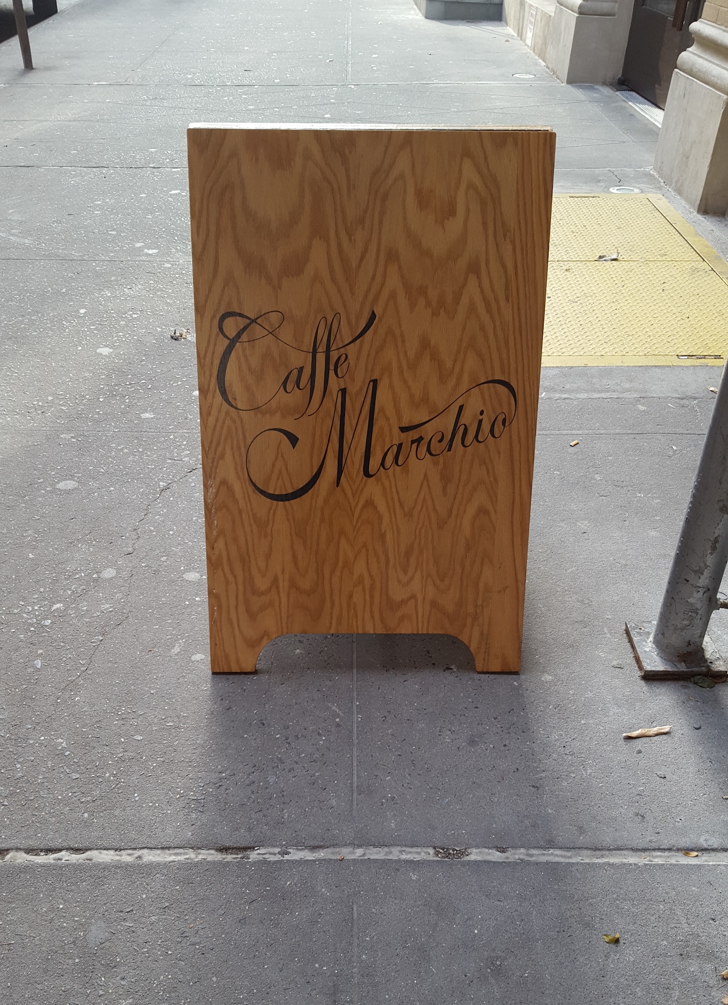 A sign in front of Caffe Marchio