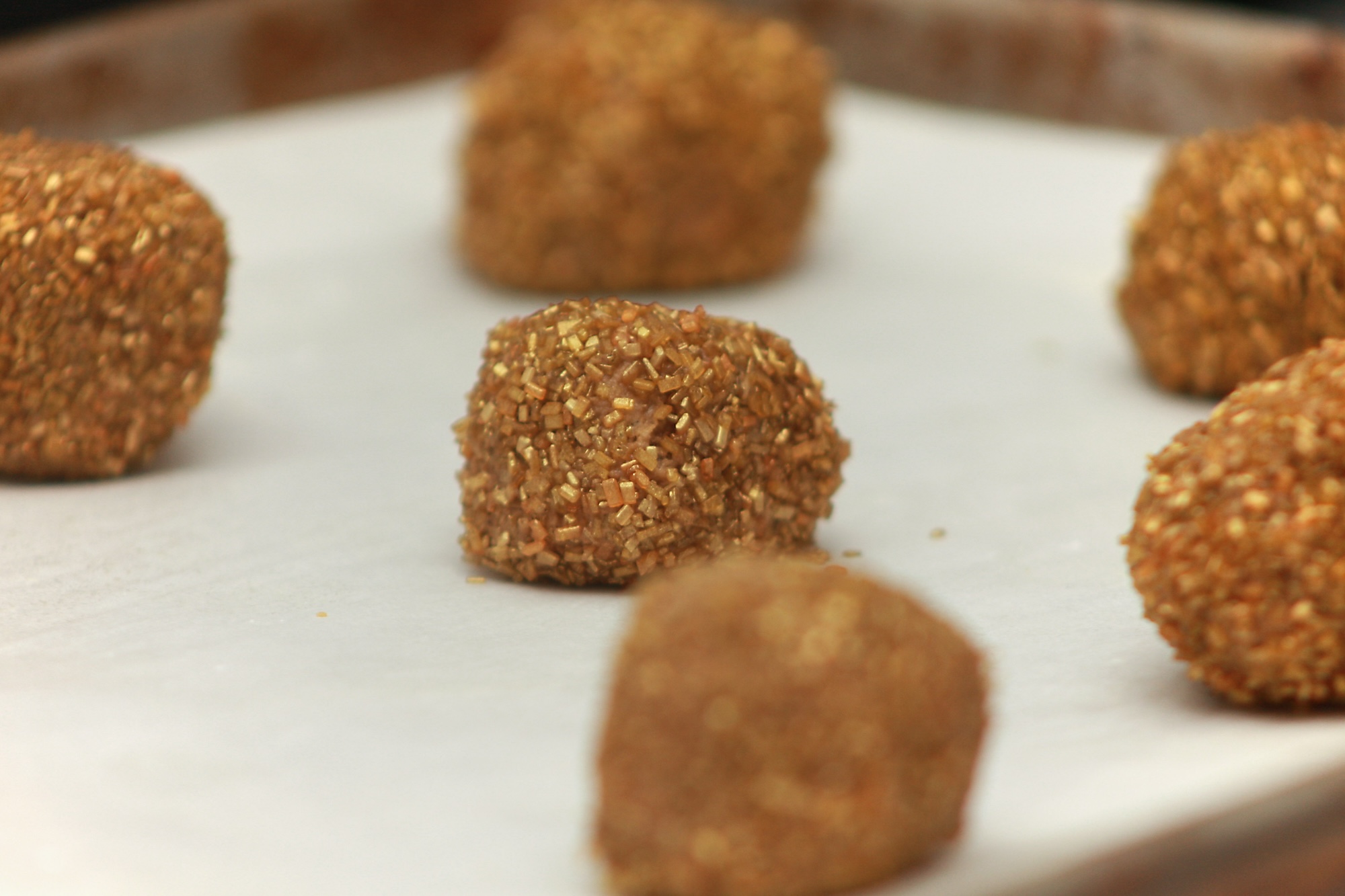 A tray of gingerbread cookie dough covered in sprinkles