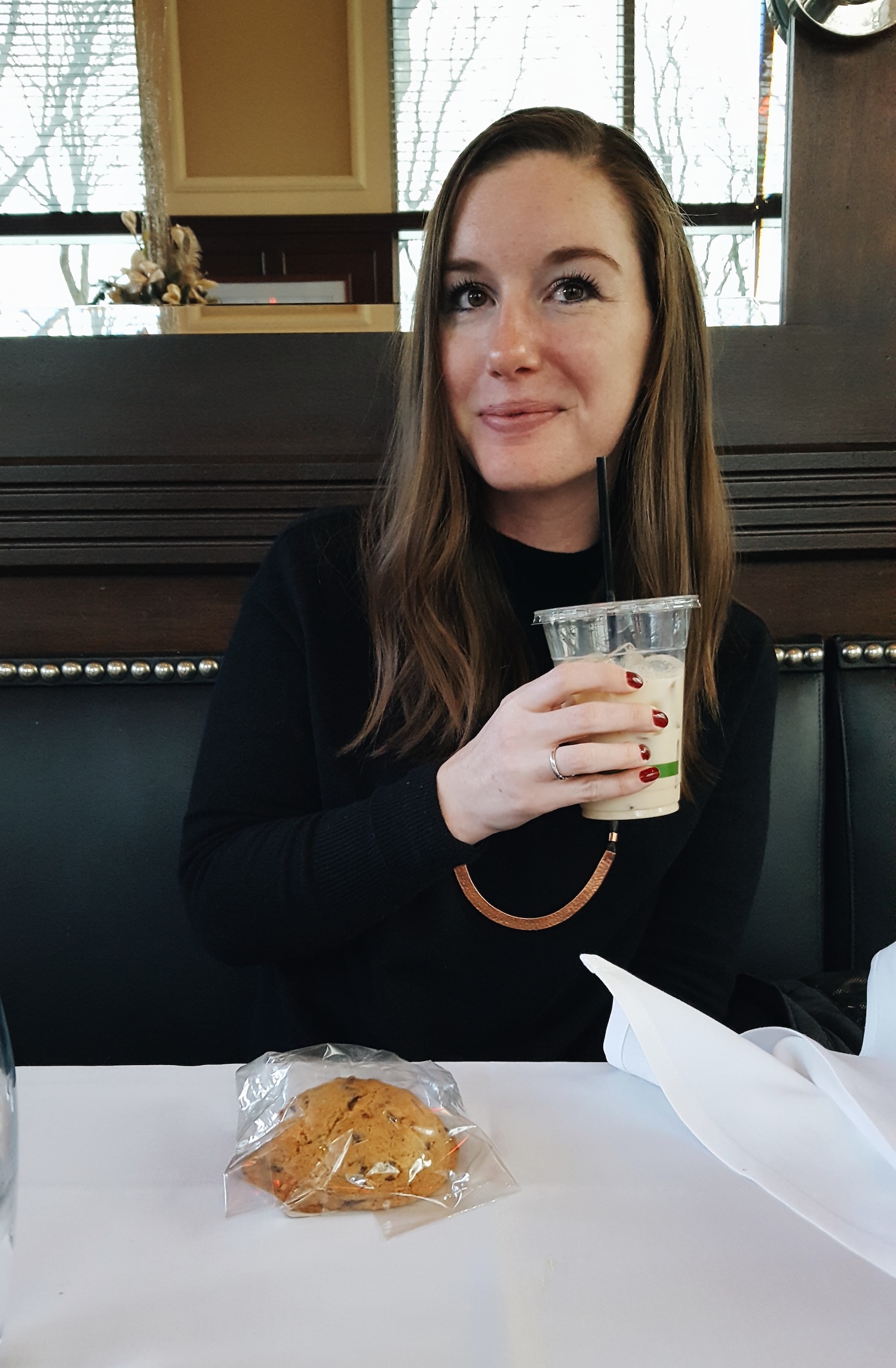 Alyssa holds a to-go cup of coffee milk, Rhode Island's state beverage