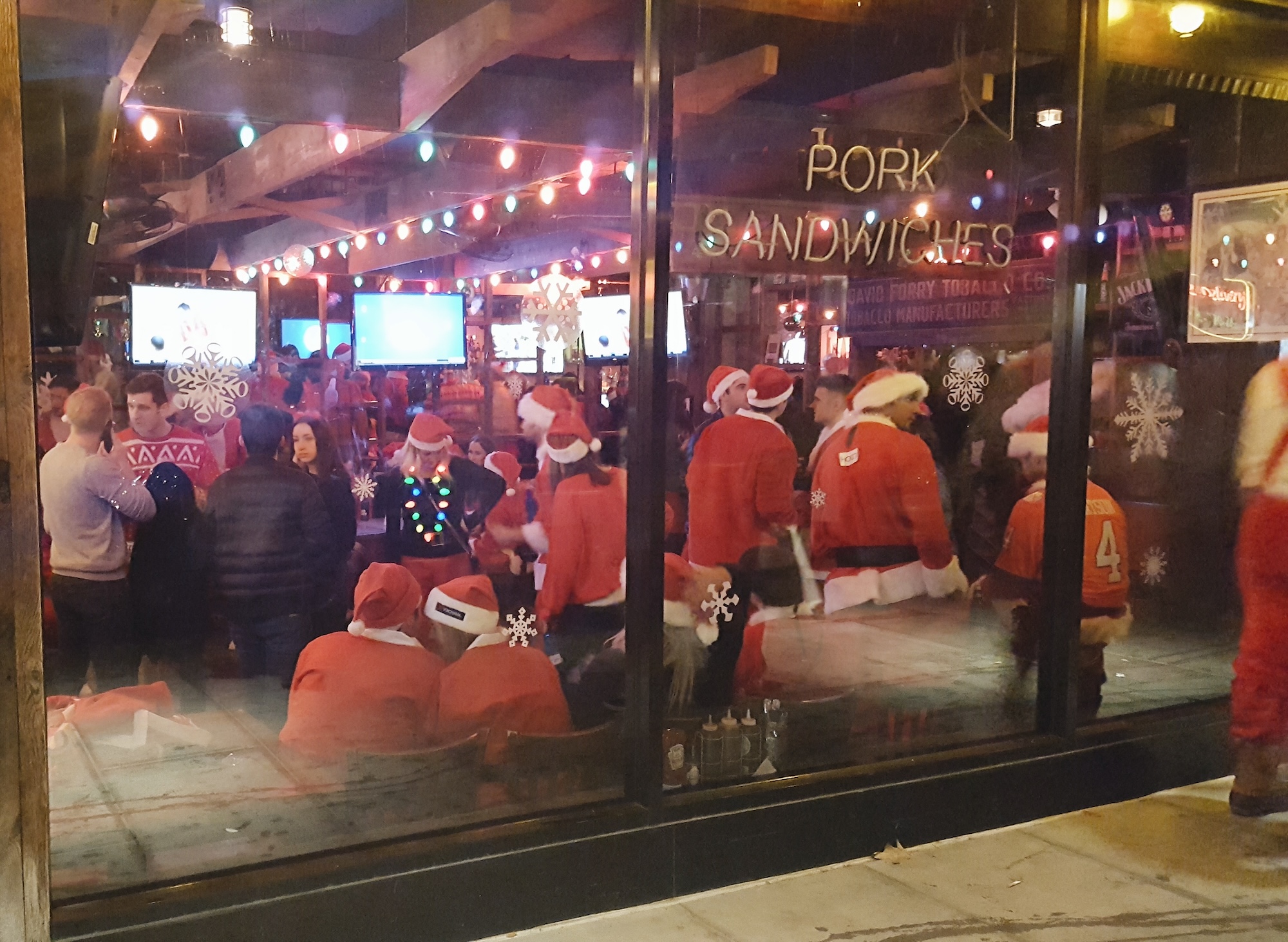 People dressed up as Santa in a NYC bar