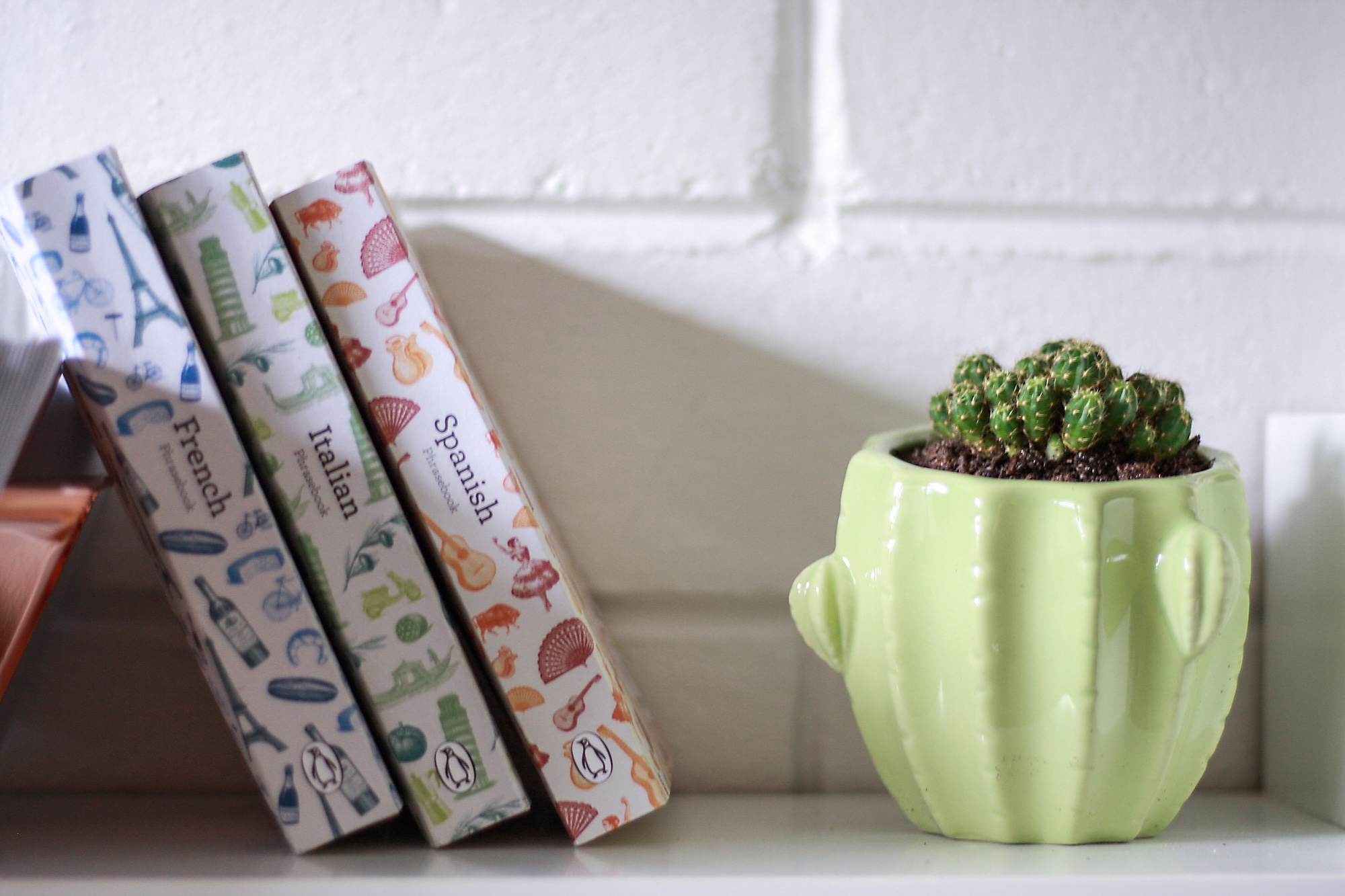 Three language books on a bookshelf