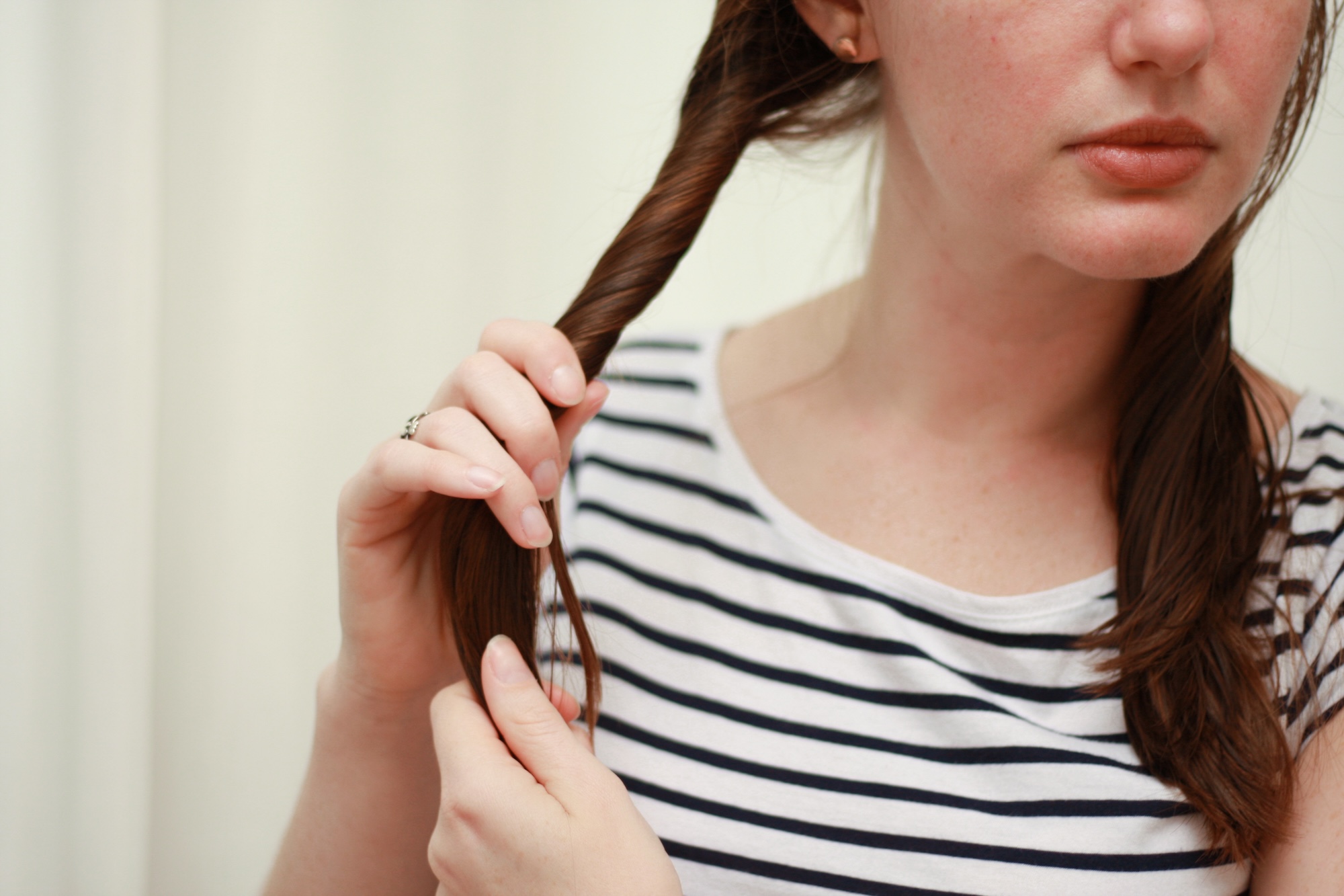 Alyssa twists her hair into pigtails