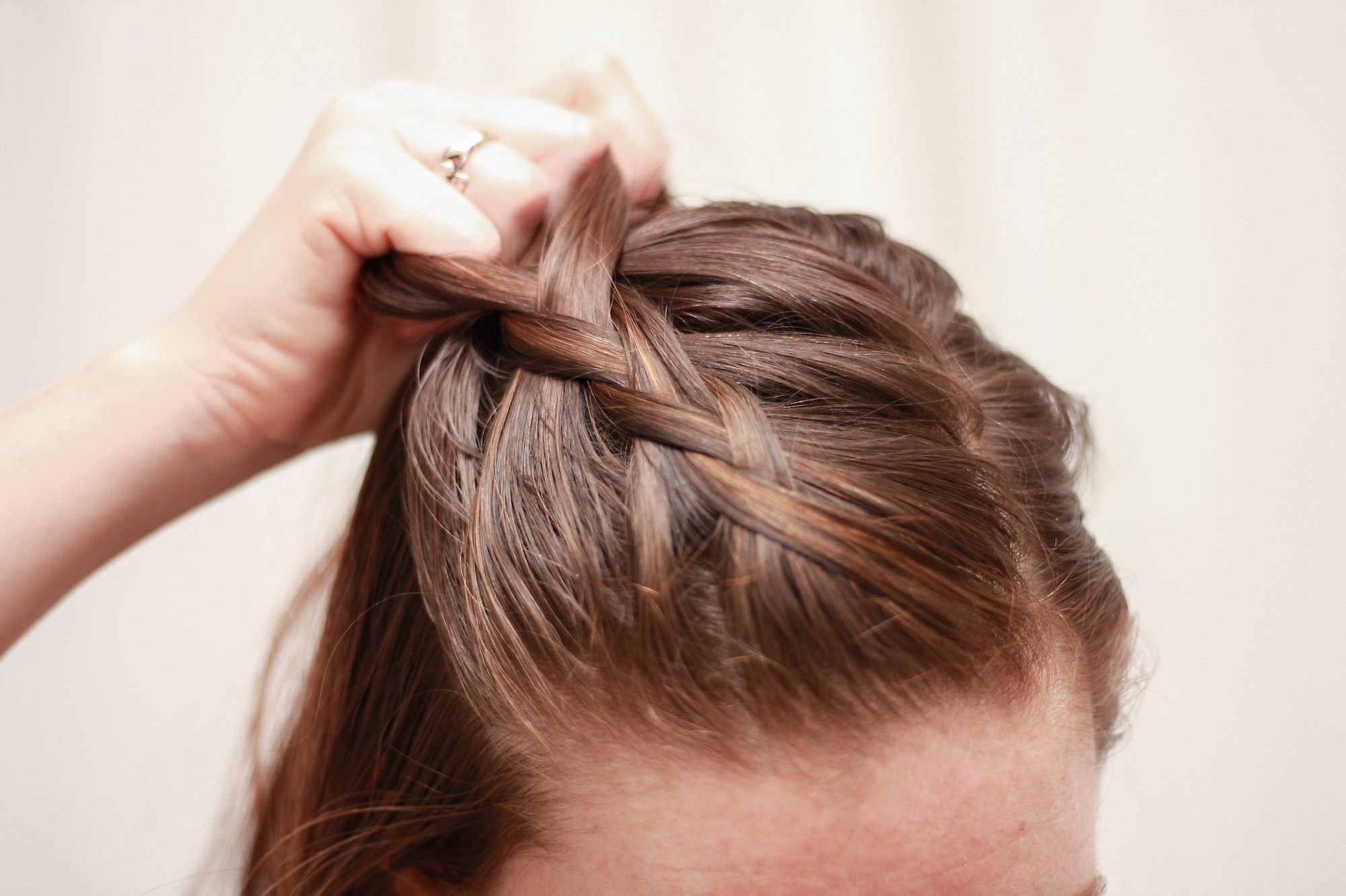 close up of creating a Dutch braid