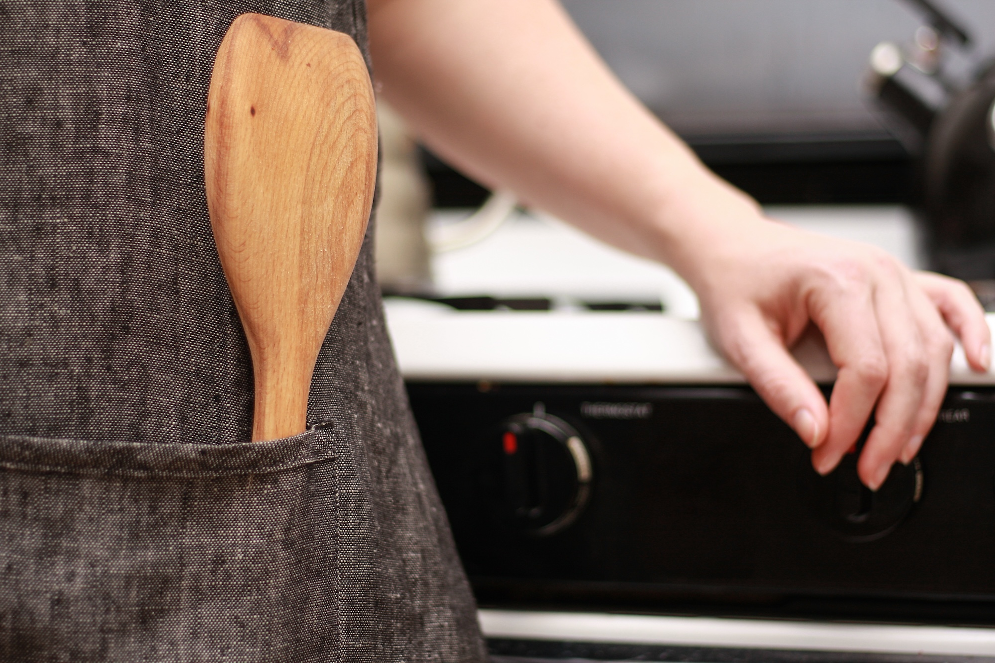 A spatula in an apron pocket