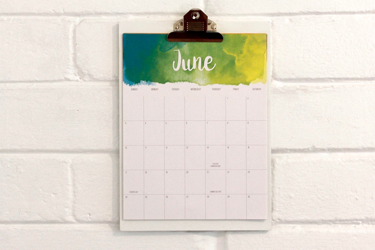 A calendar on the wall, flipped to the page for June