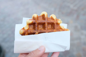 Michael holds a waffle from Chez Albert