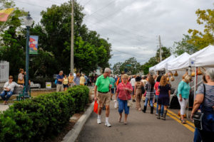 A crowd browses vendors in tents at the festival in Mount Dora