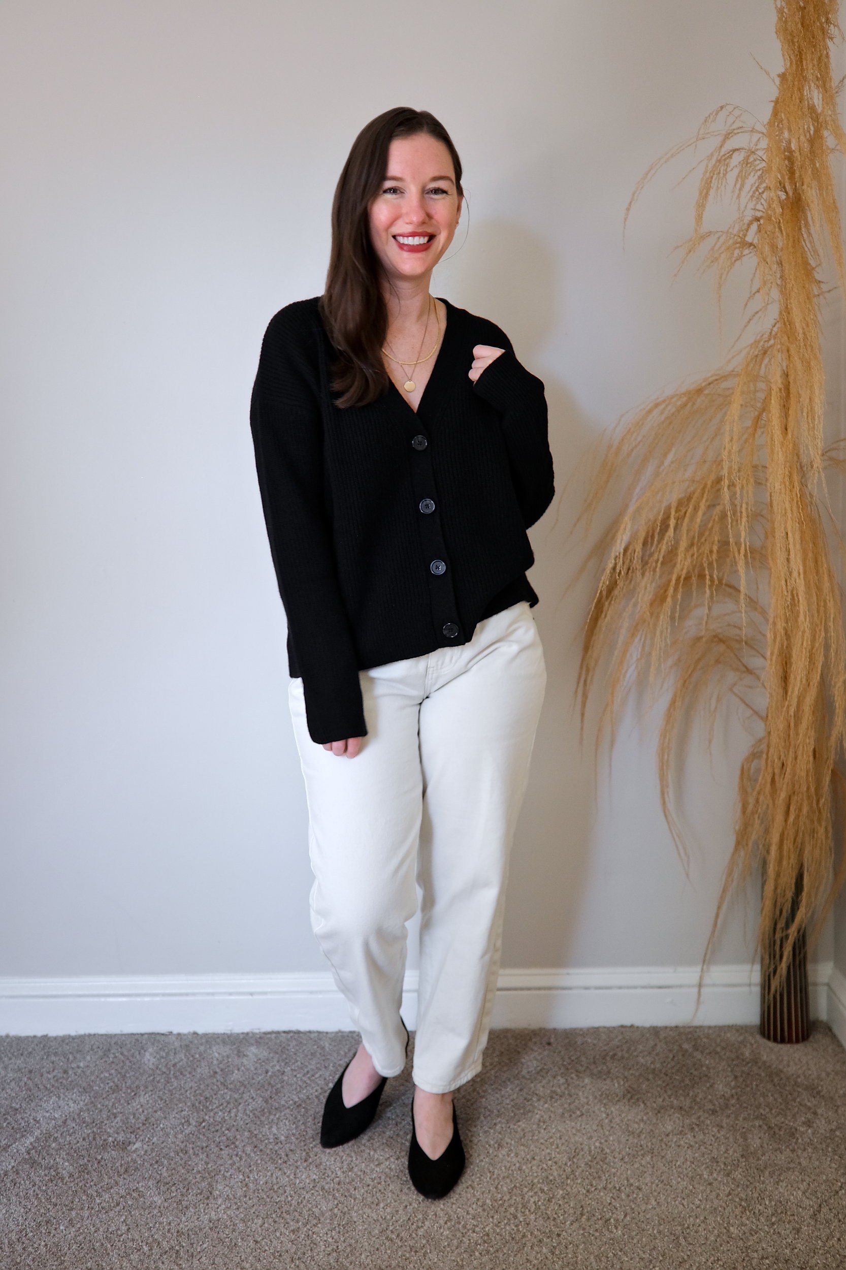 Alyssa wears the Mongolian Cashmere Fisherman Cropped Cardigan Sweater buttoned up with with white denim and heels