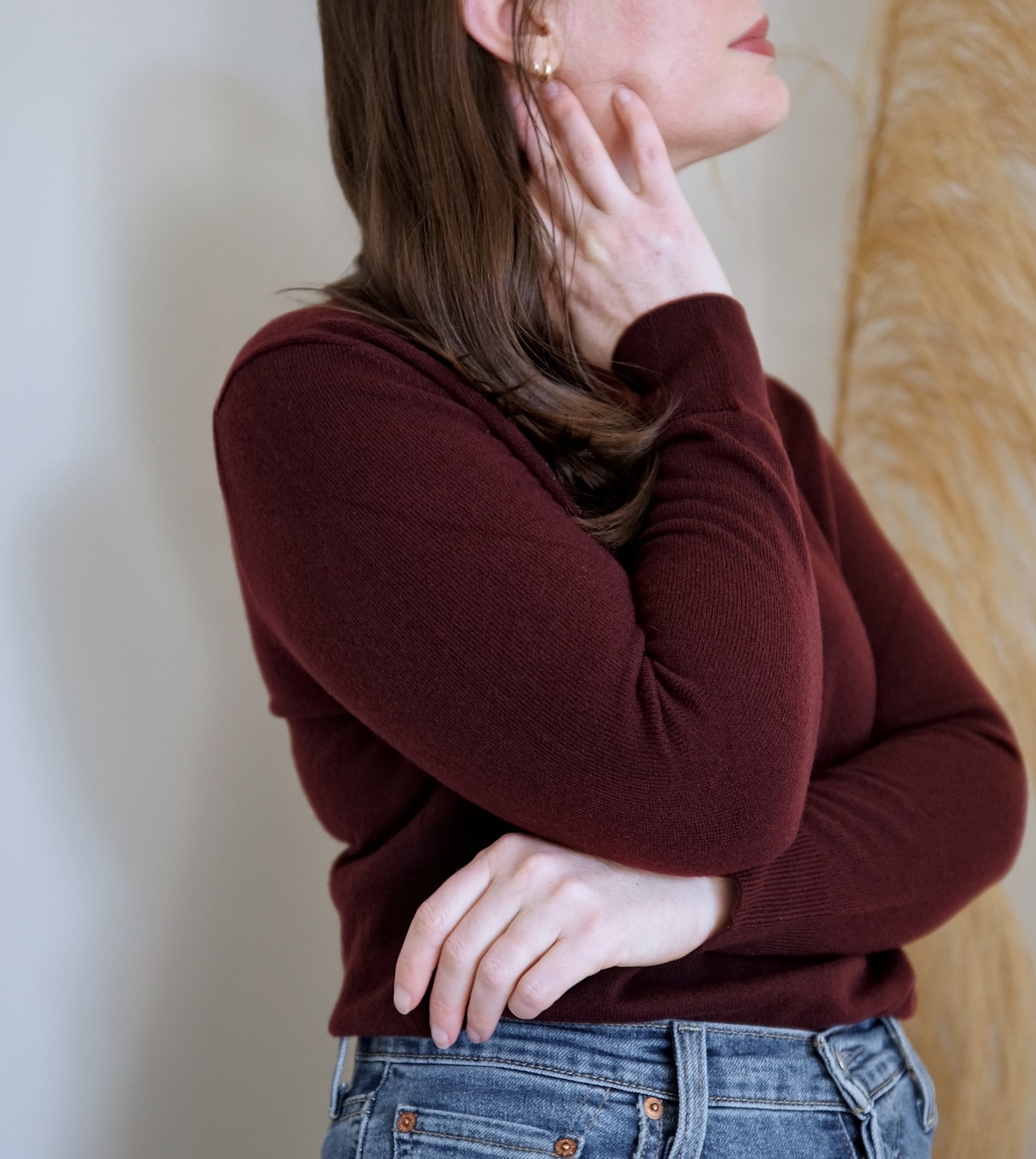 Alyssa crosses her arms and looks up while wearing Quince cashmere sweater