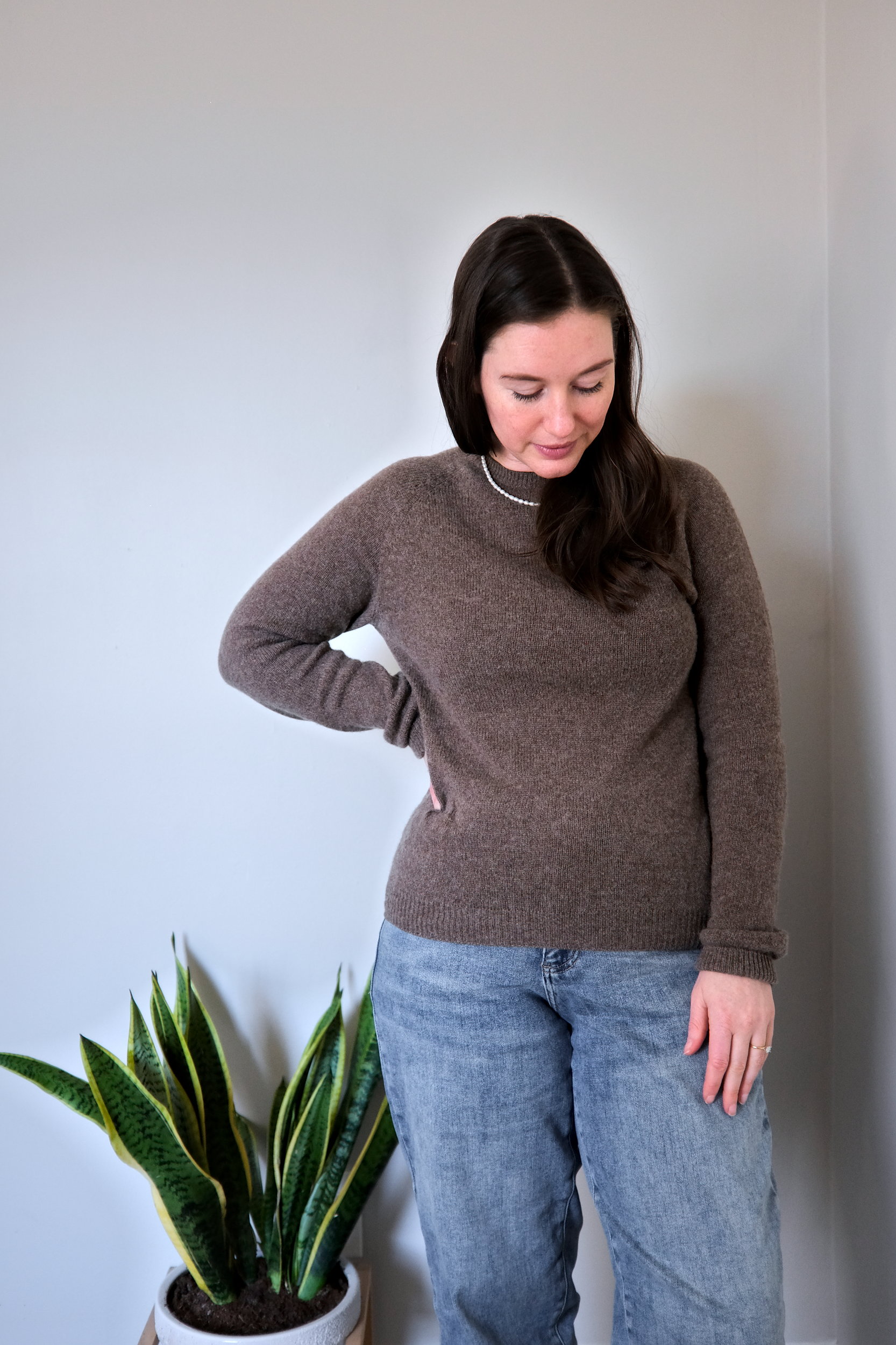 Alyssa wears a yak sweater from Quince in soft brown, leaving it untucked