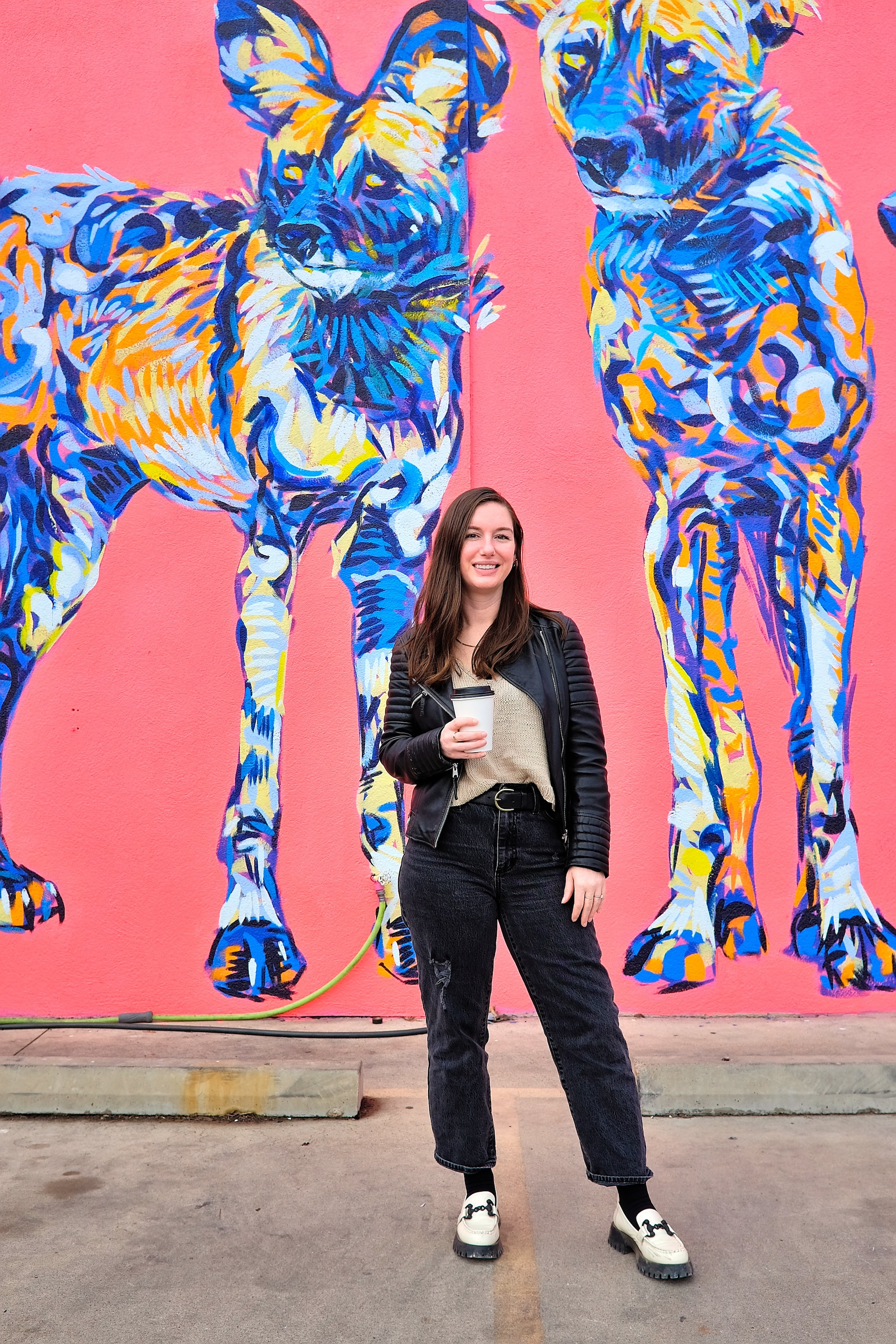 Alyssa in front of a mural in Austin