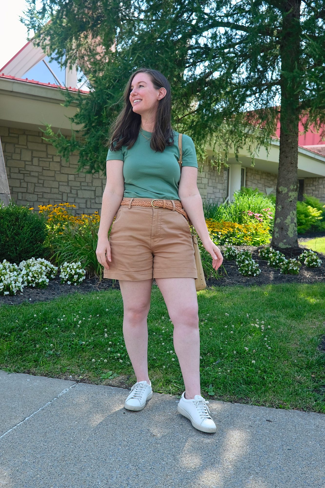 Alyssa wears a green top with brown shorts