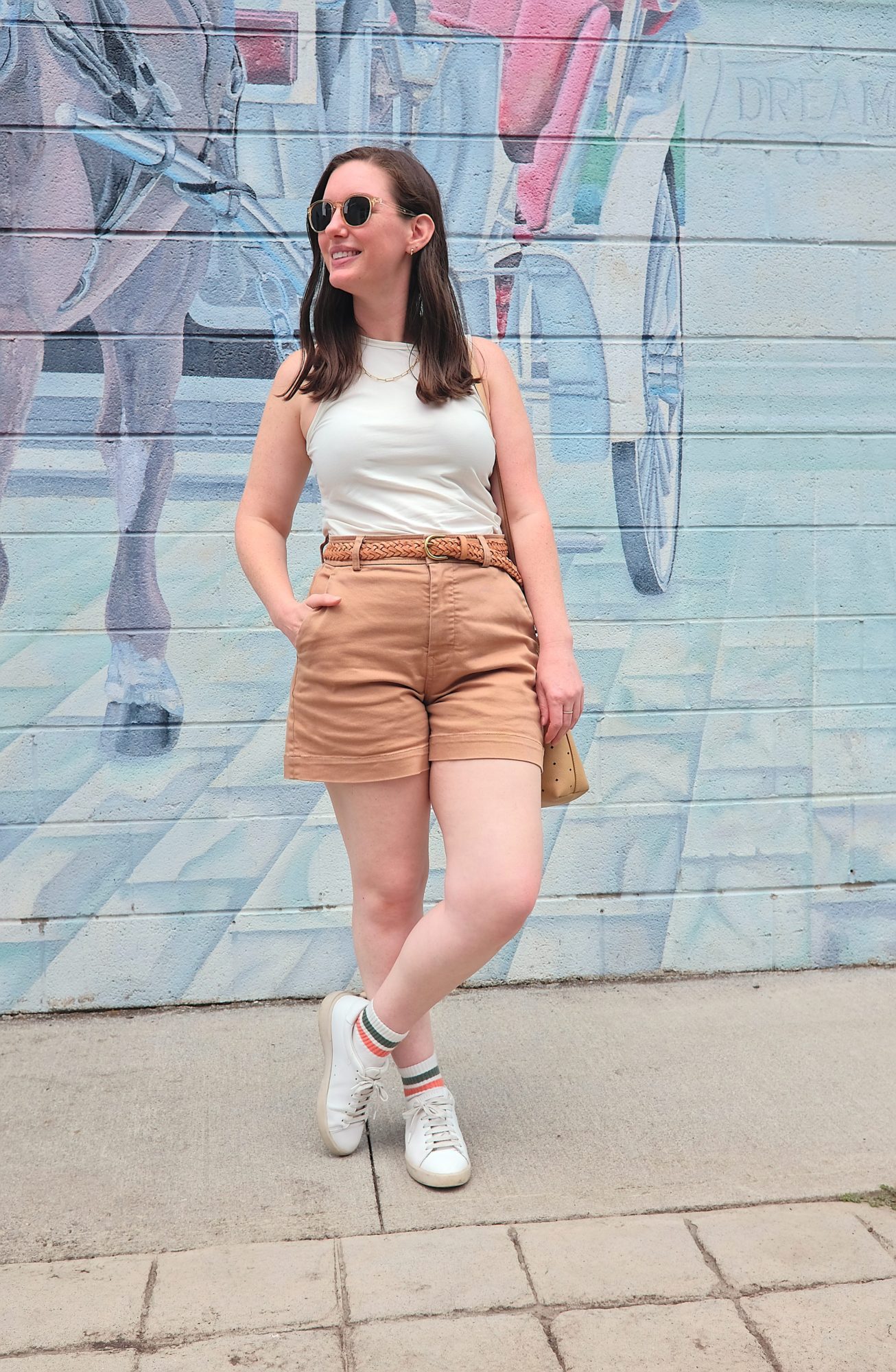 Alyssa stands in front of a mural in Hinton