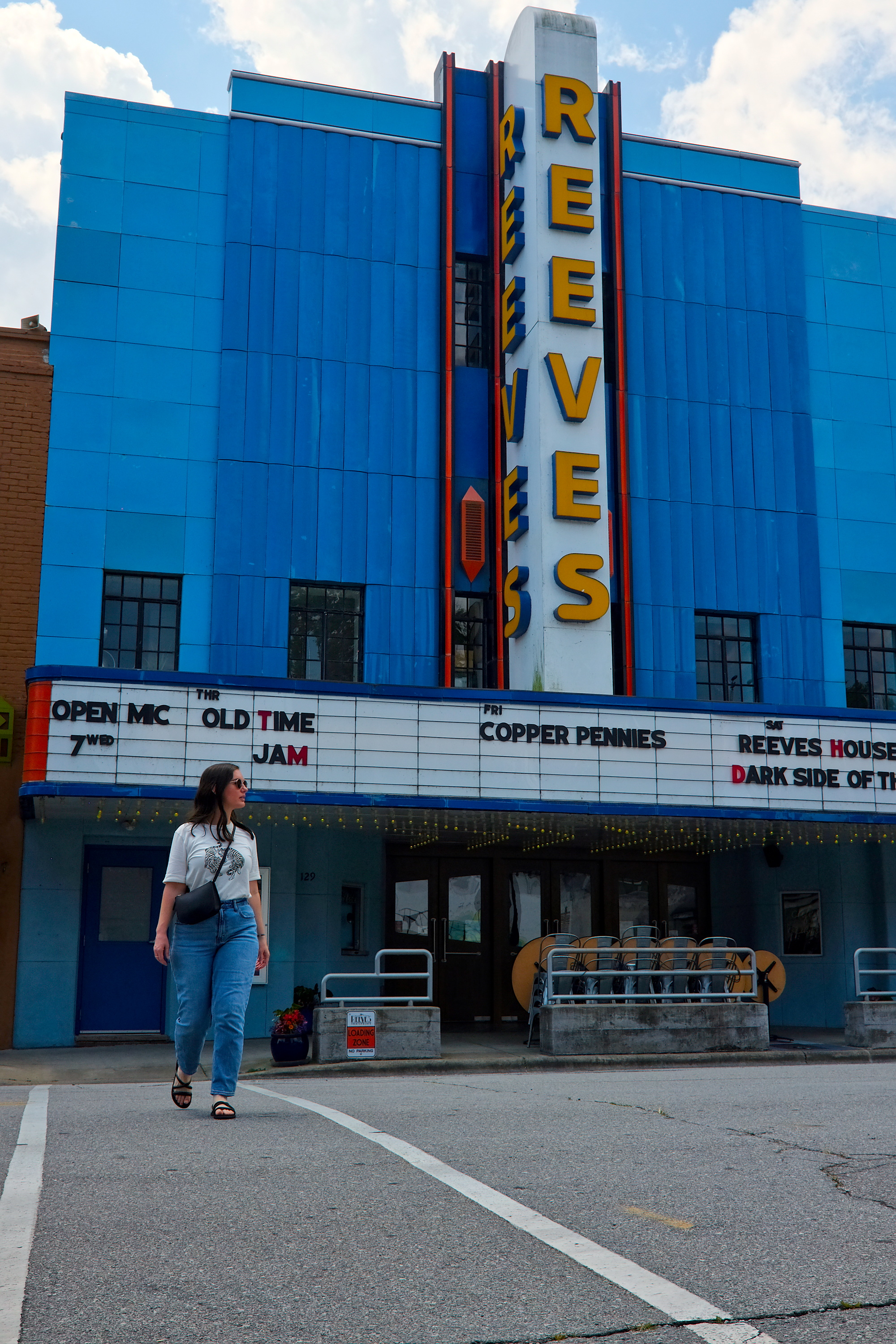 Alyssa walks in front of The Reeves Theater in Elkin