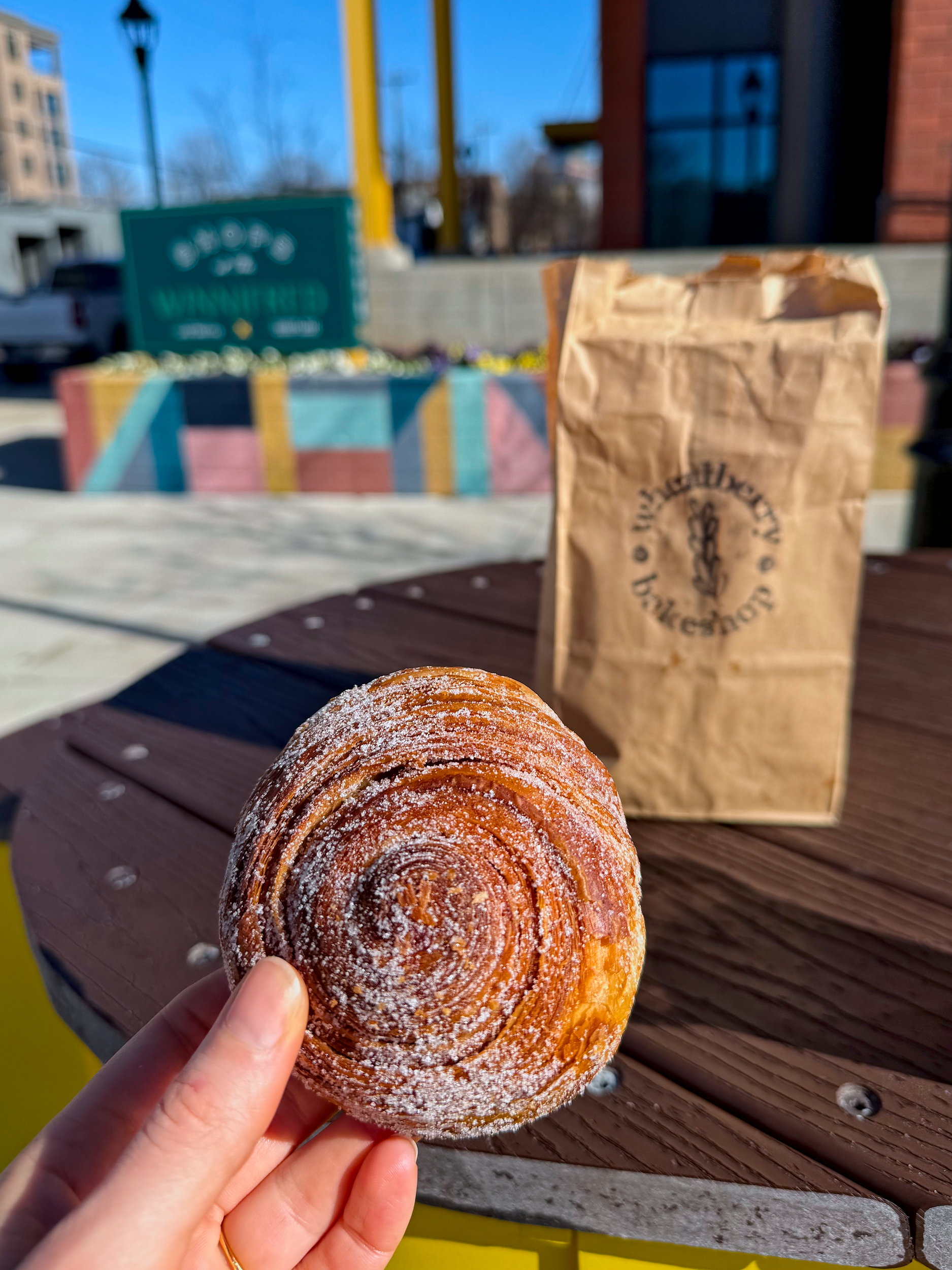 Alyssa holds a morning bun from Wheatberry Bakeshop