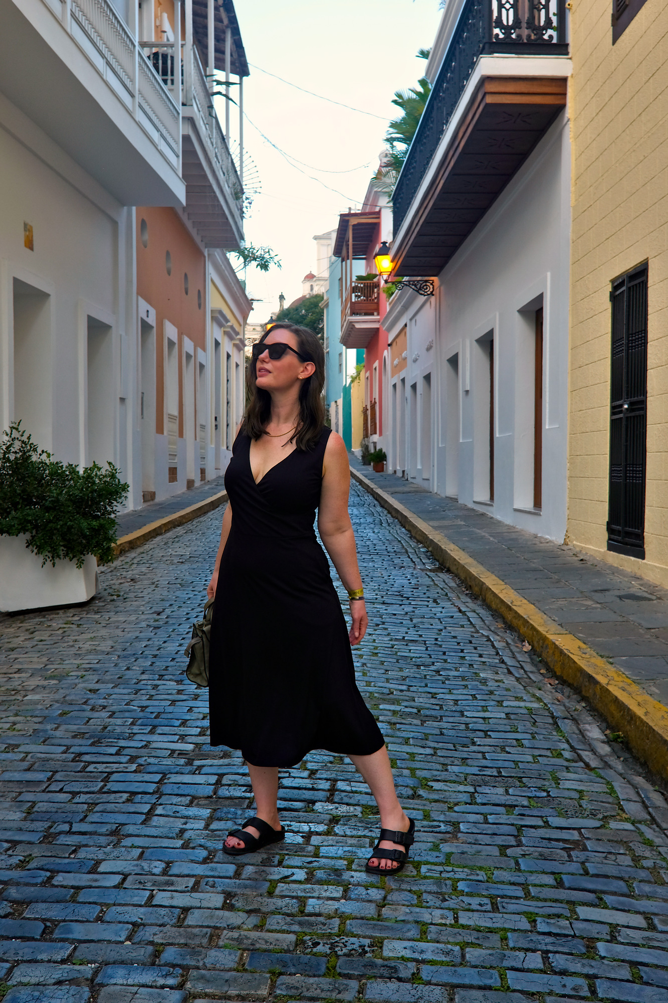 Alyssa wears a black wrap dress in Old San Juan