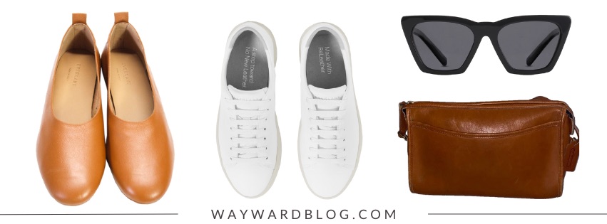 A pair of flats, a pair of sneakers, a pair of sunglasses, and a leather bag