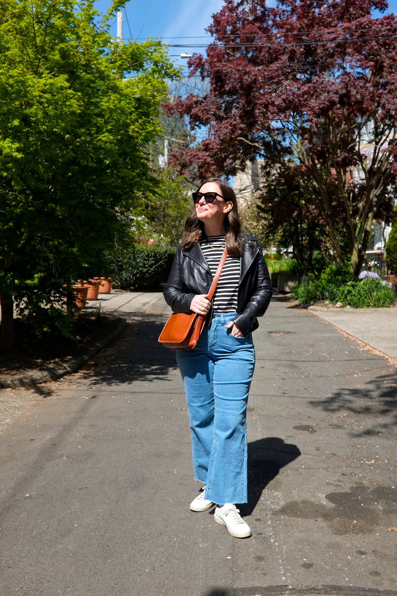 Alyssa wears a striped tee and jeans