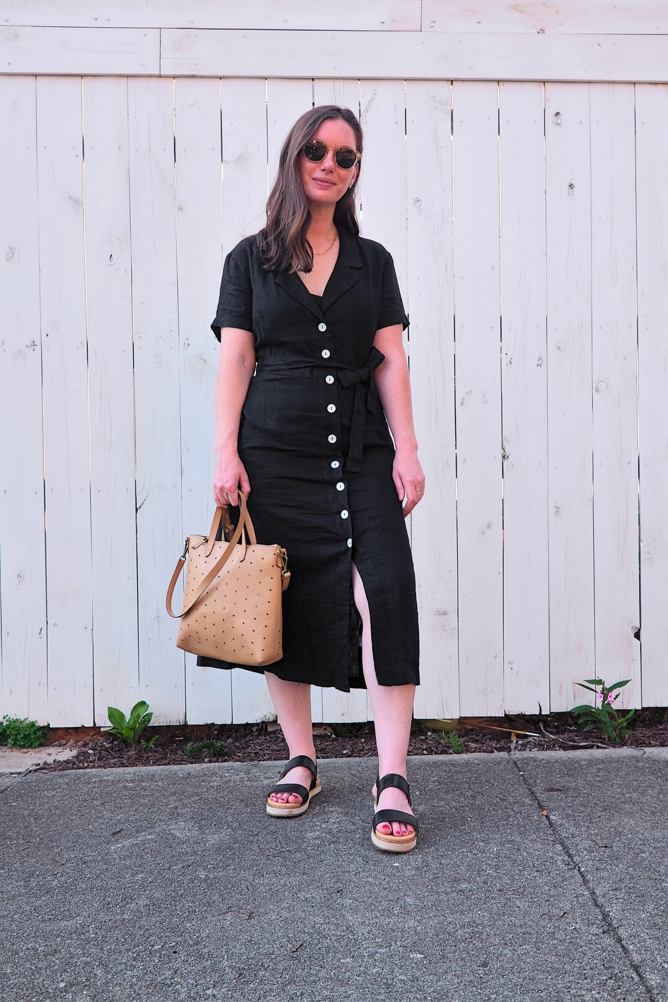 Alyssa wears a Quince button-down dress with sandals and sunglasses