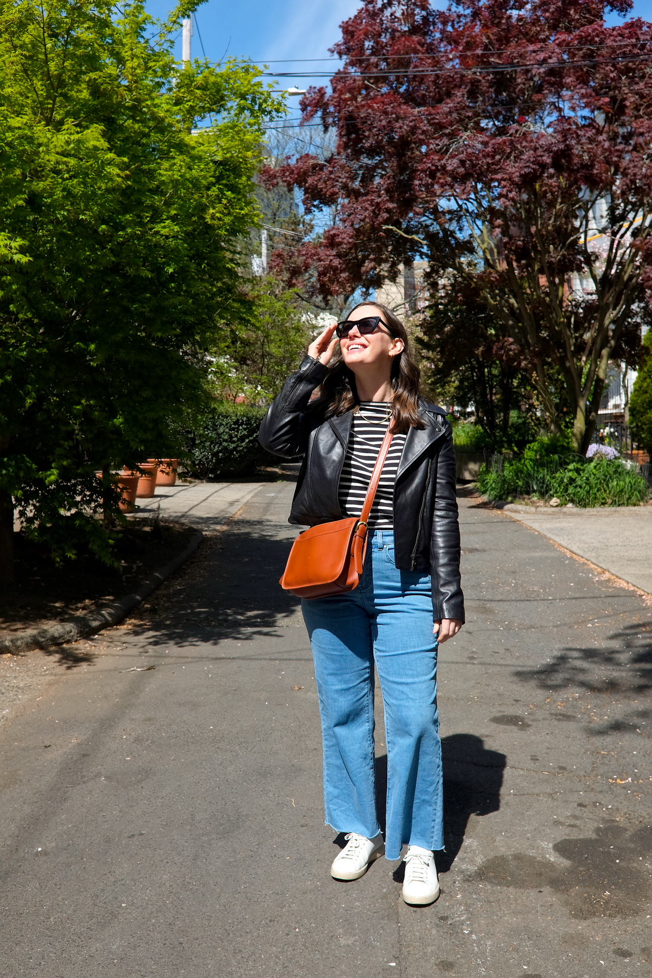 Alyssa wears a striped tee with jeans and sneakers