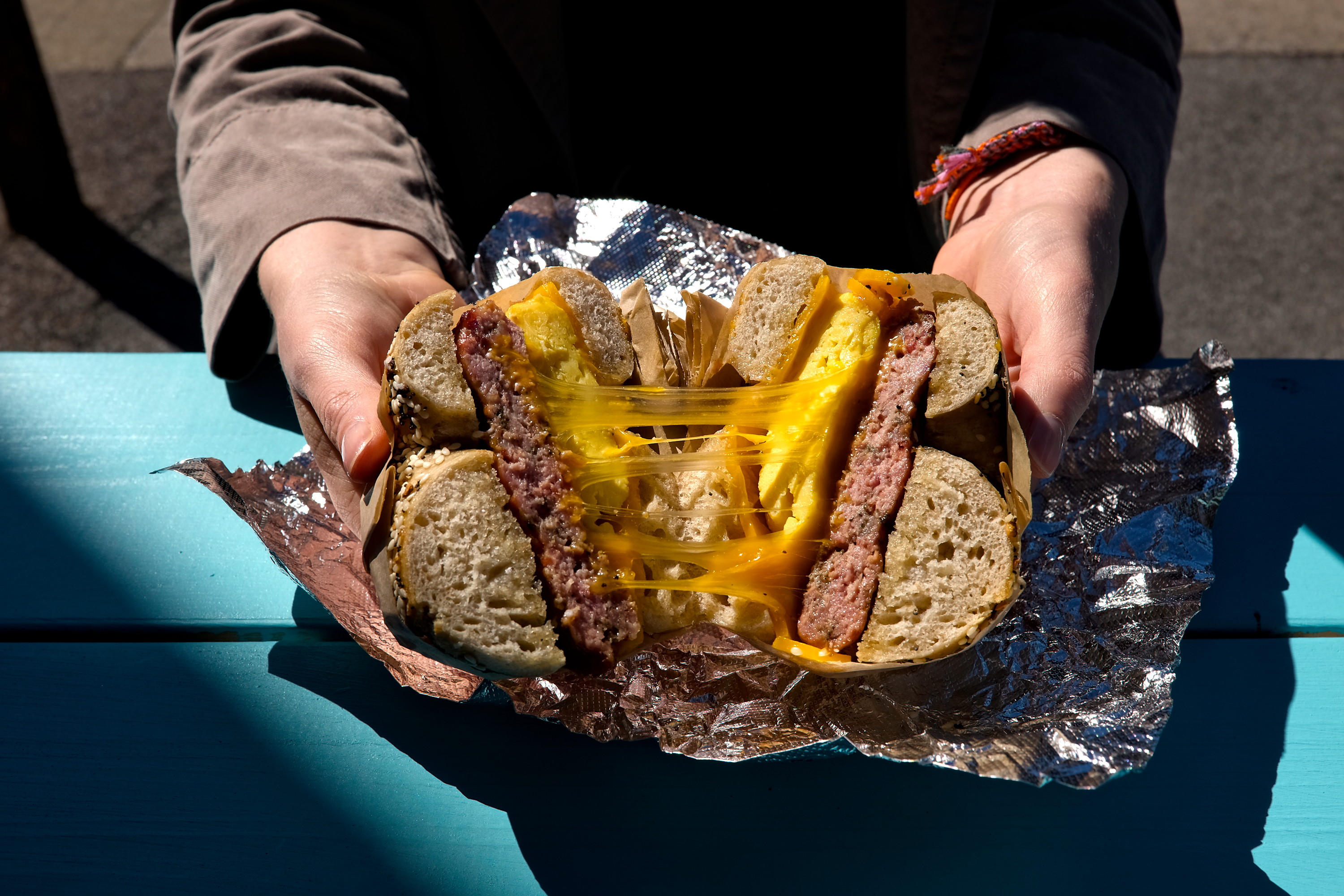 Alyssa opens a bagel sandwich