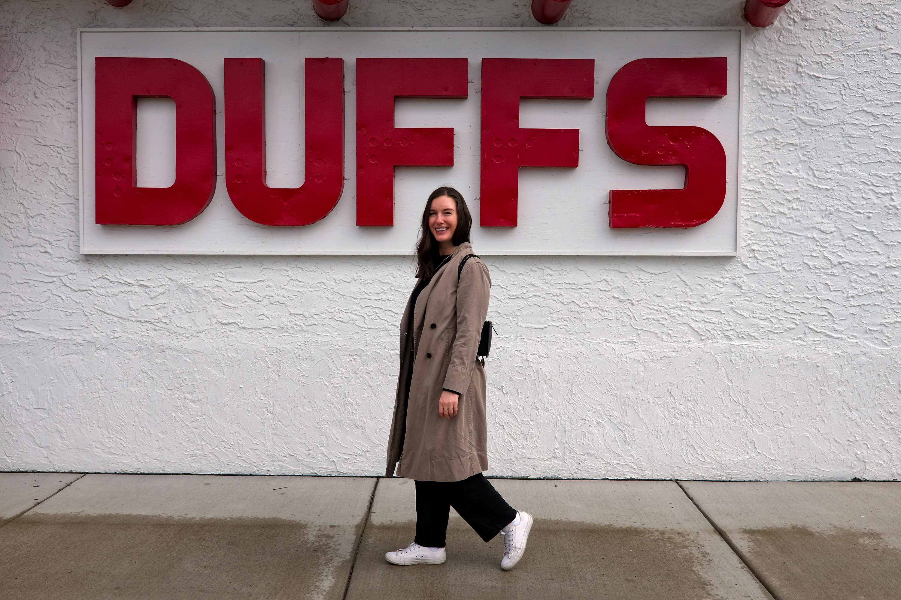 Alyssa walks in front of the Duffs sign in Buffalo