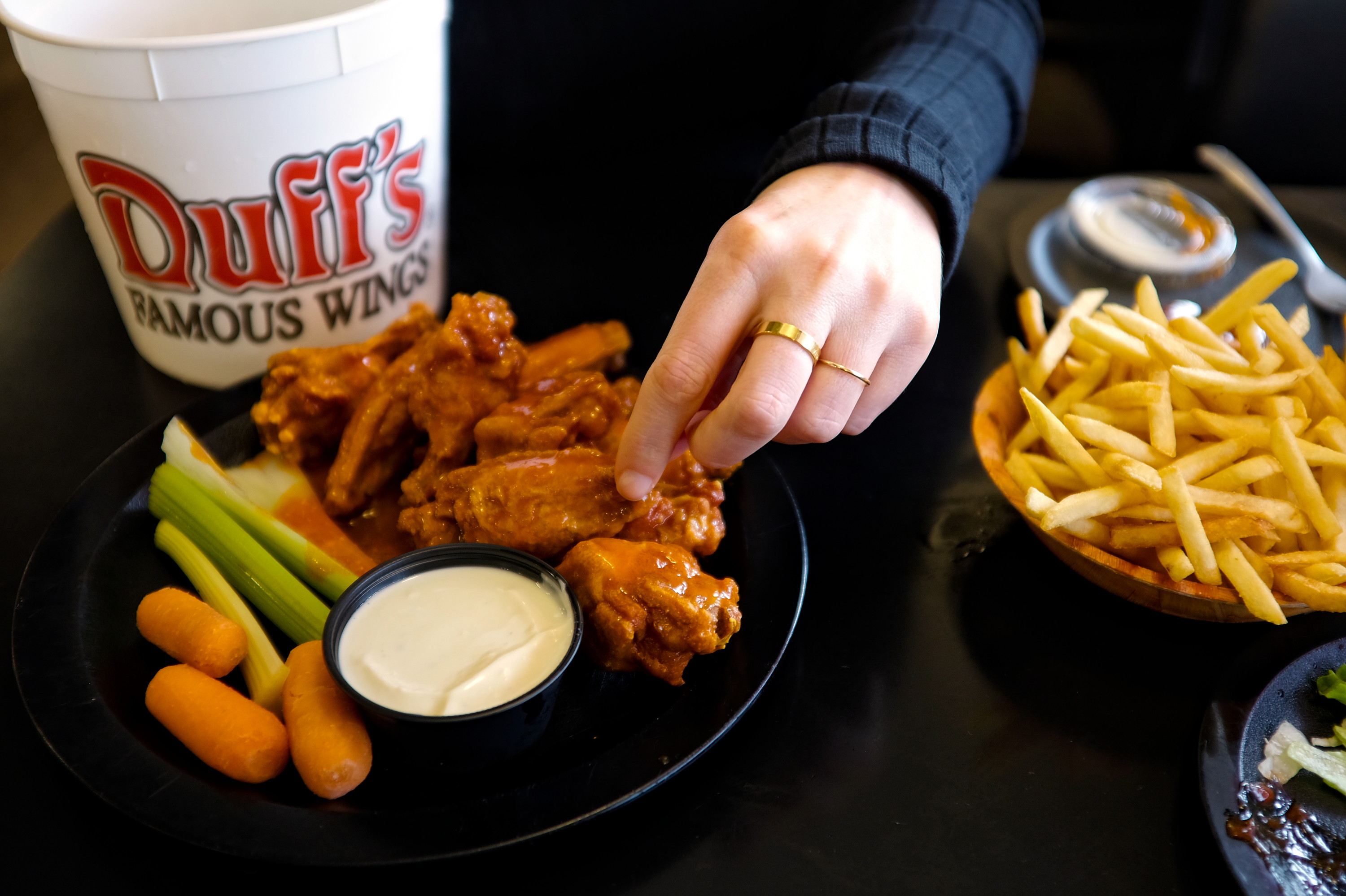 Alyssa grabs a wing at Duff's