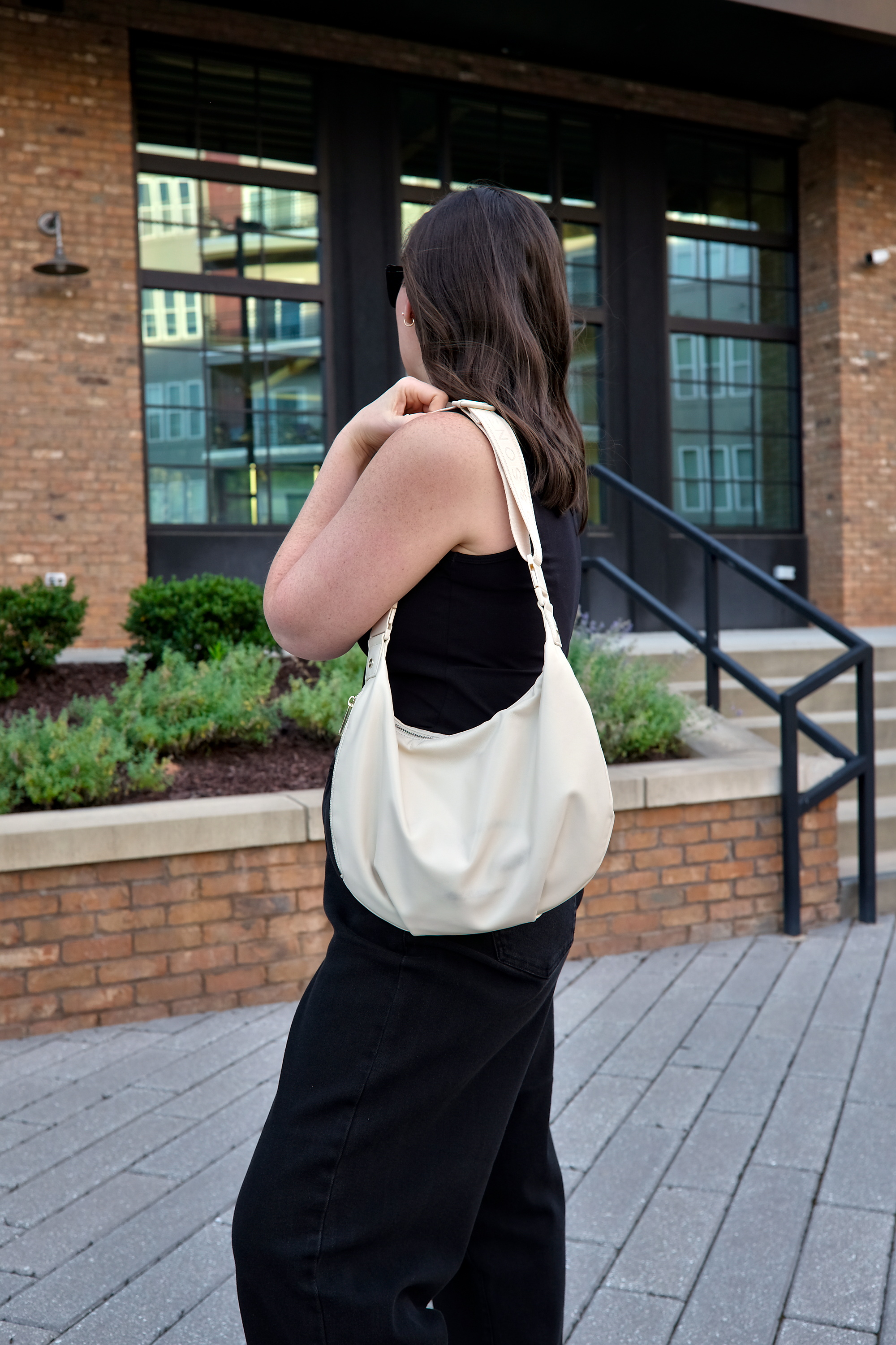 Alyssa wears all black and carries the Aoyama Bag from Lo & Sons
