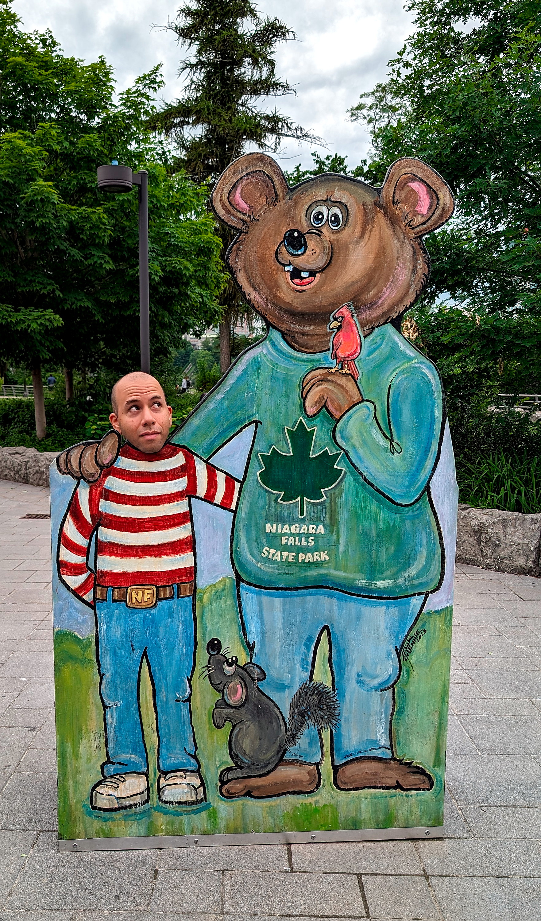 Michael takes a photo in a cutout at Niagara Falls State Park