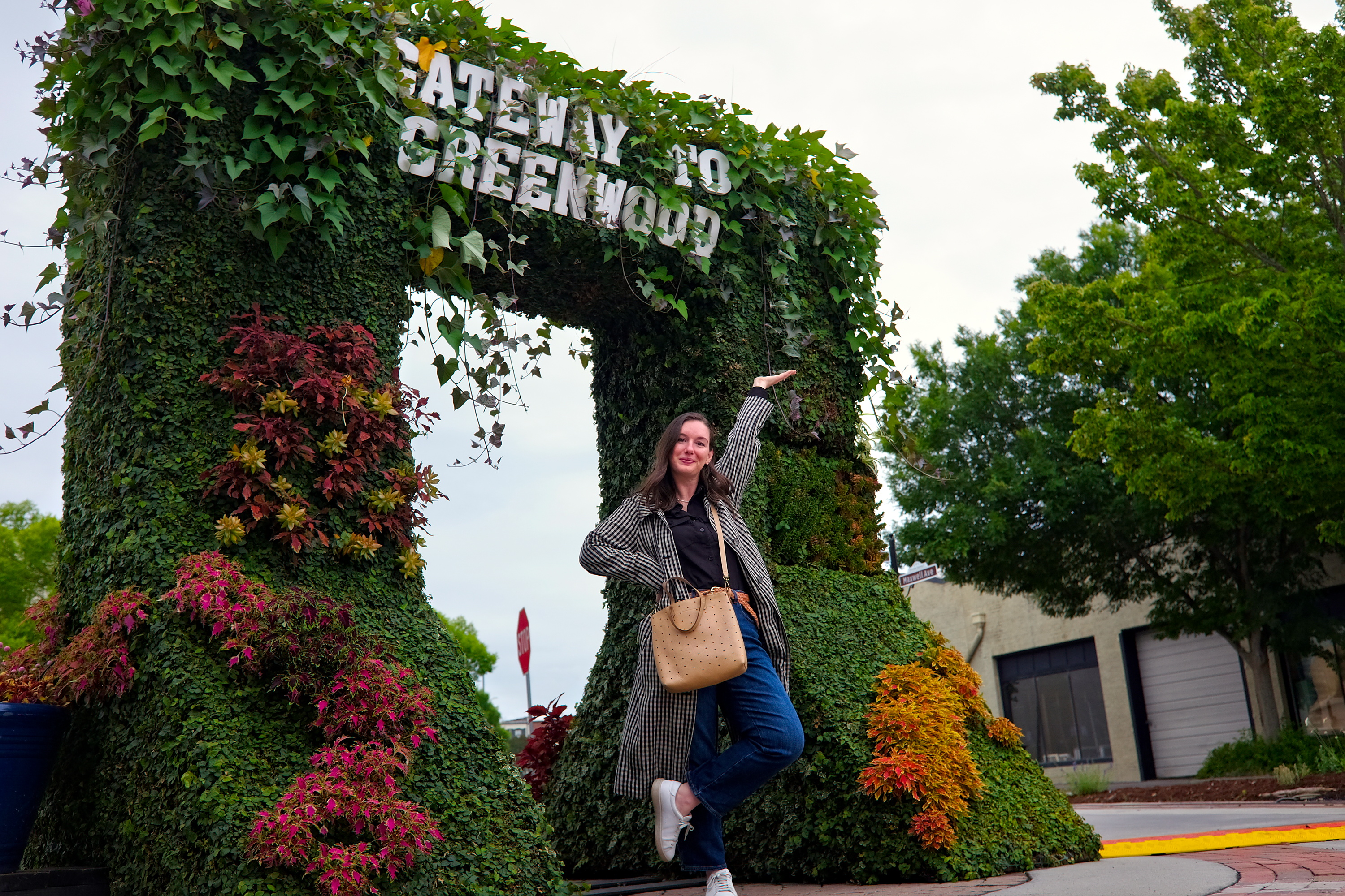 Alyssa under a Gateway to Greenwood sign