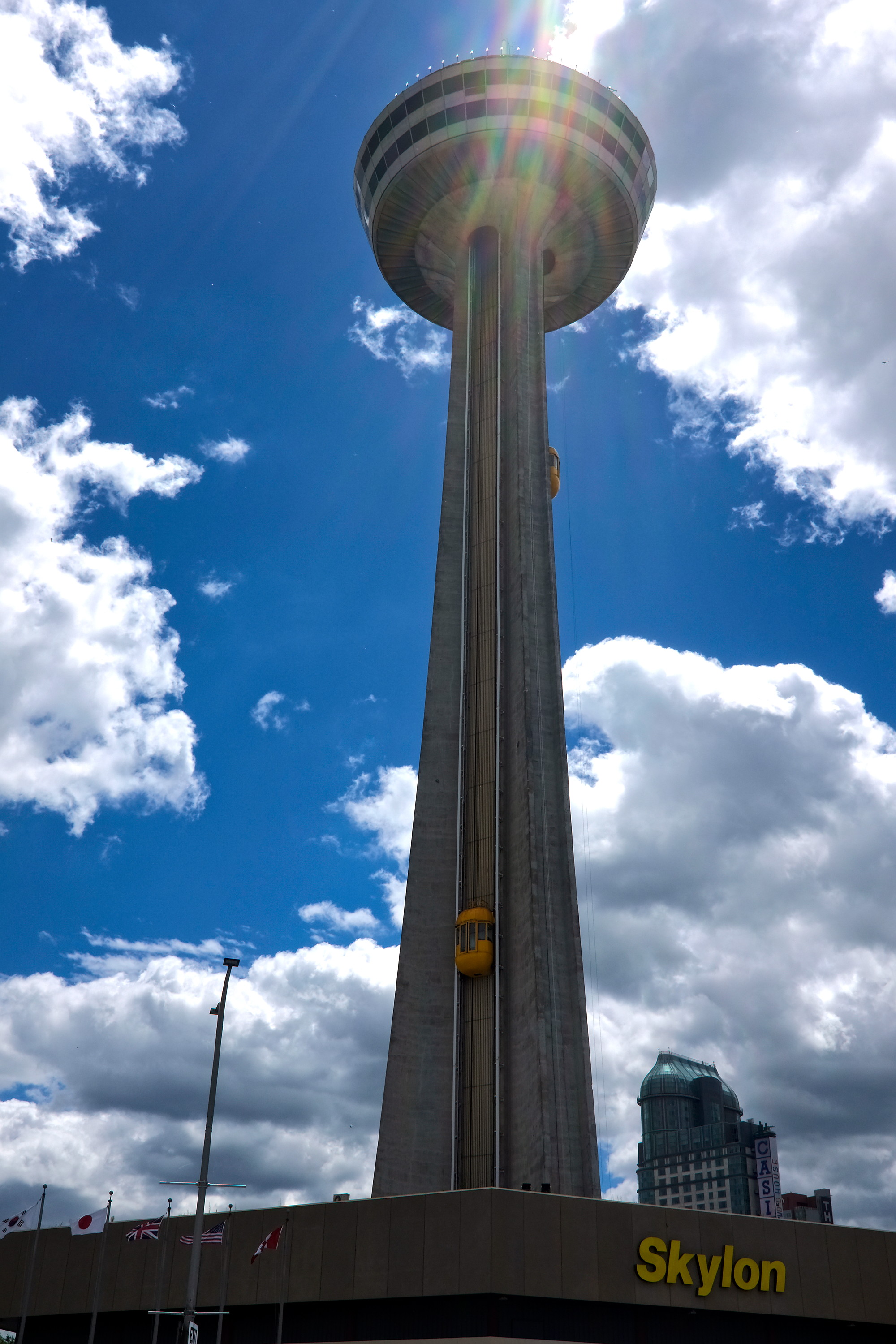 Yellow cars go up and down the sides of the Skylon Tower