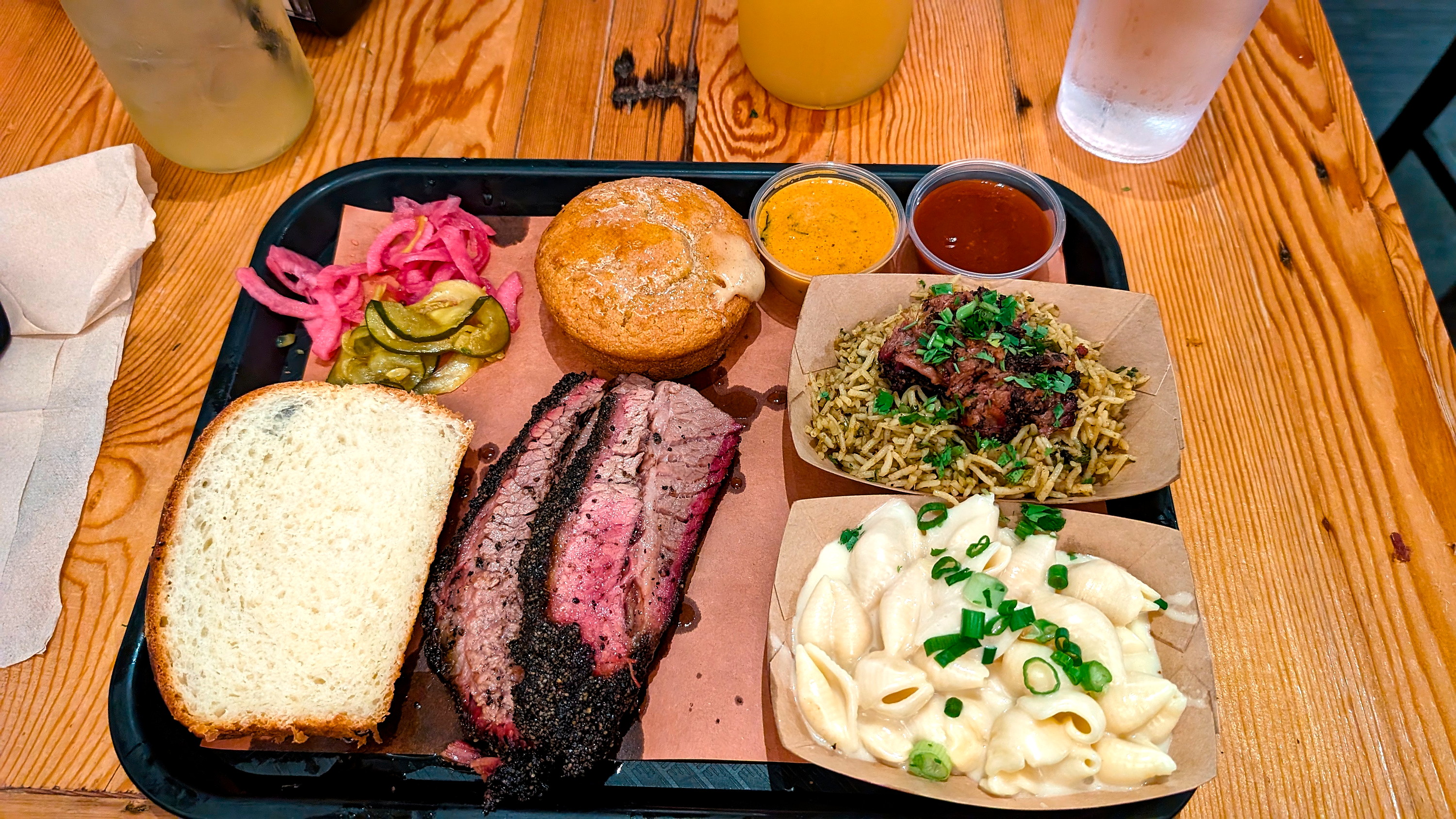 A plate of brisket, mac and cheese, cornbread, and more