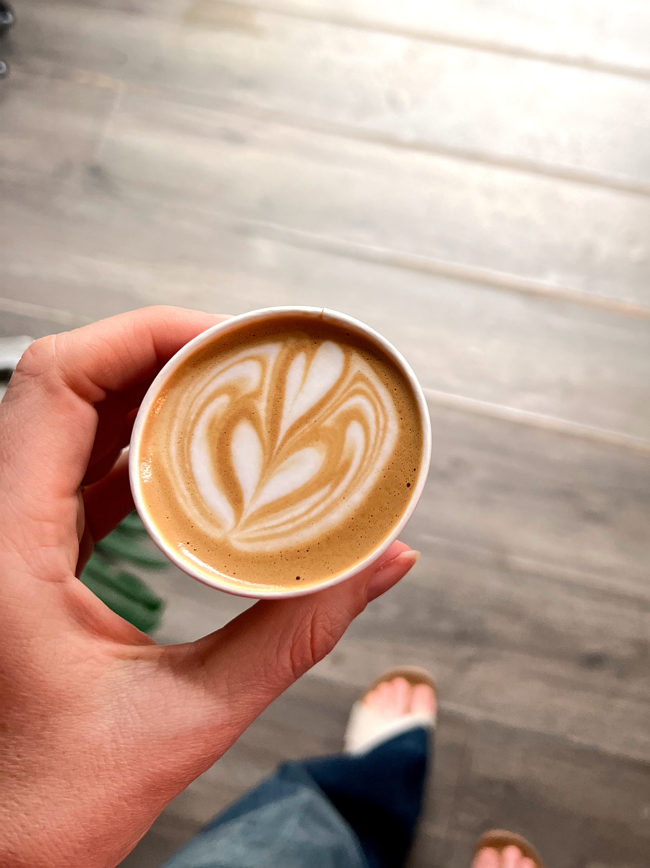 Alyssa holds a cortado in her hand