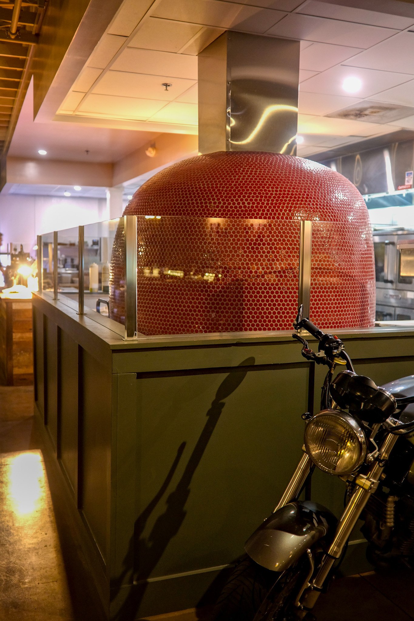 A Ducati in front of a pizza oven