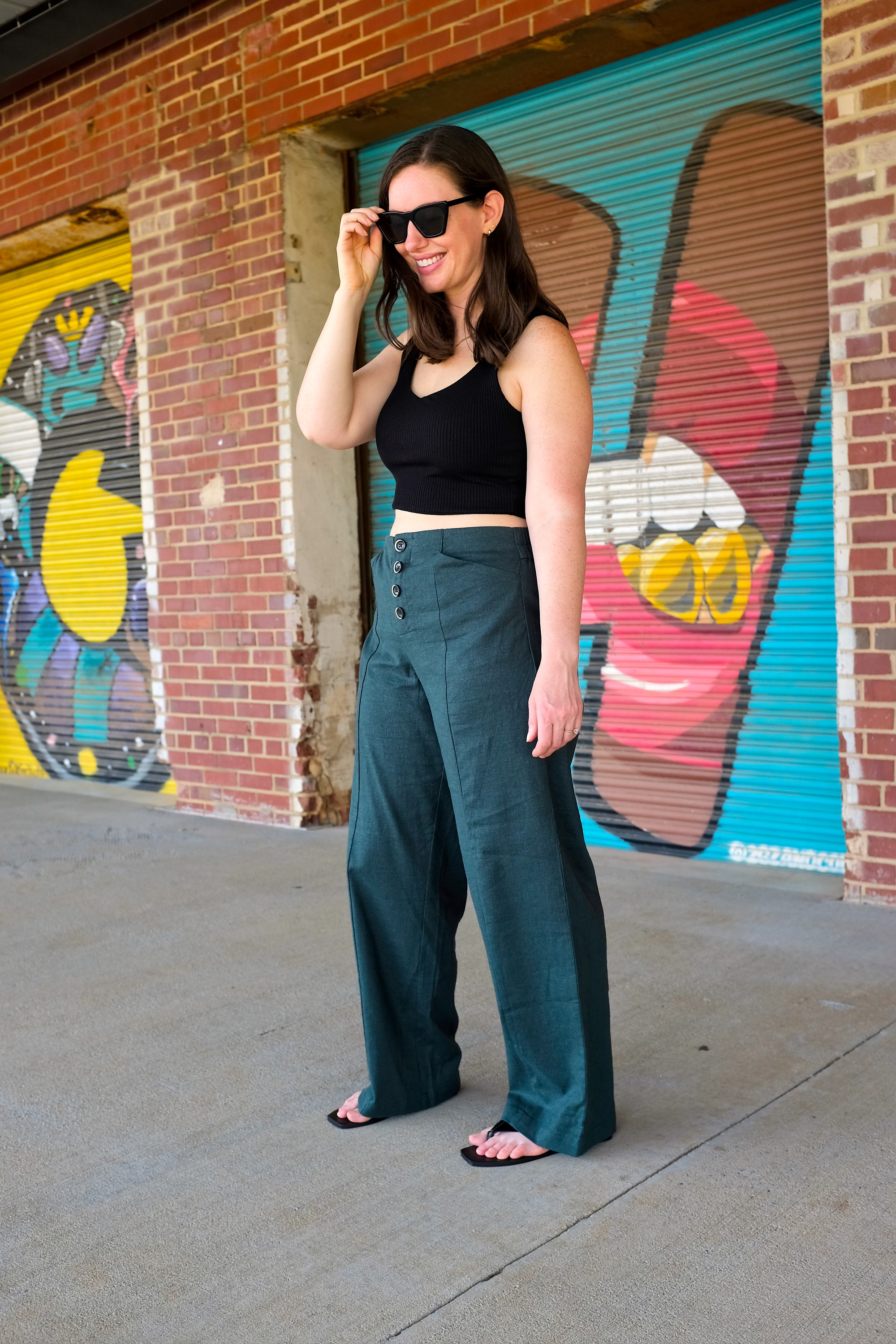 Alyssa wears linen trousers from Universal Standard with a crop top