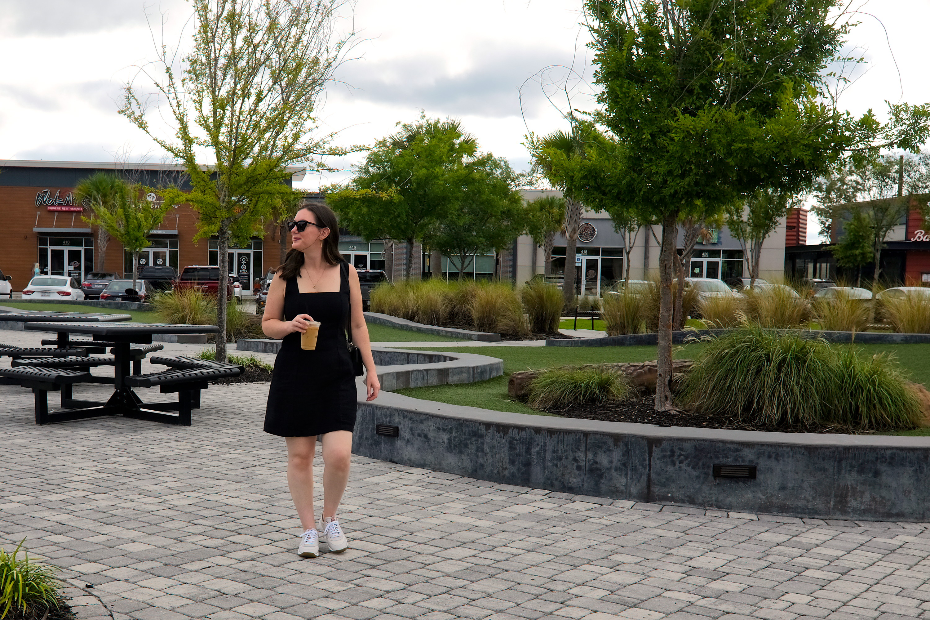 Alyssa walks through a plaza in Nexton