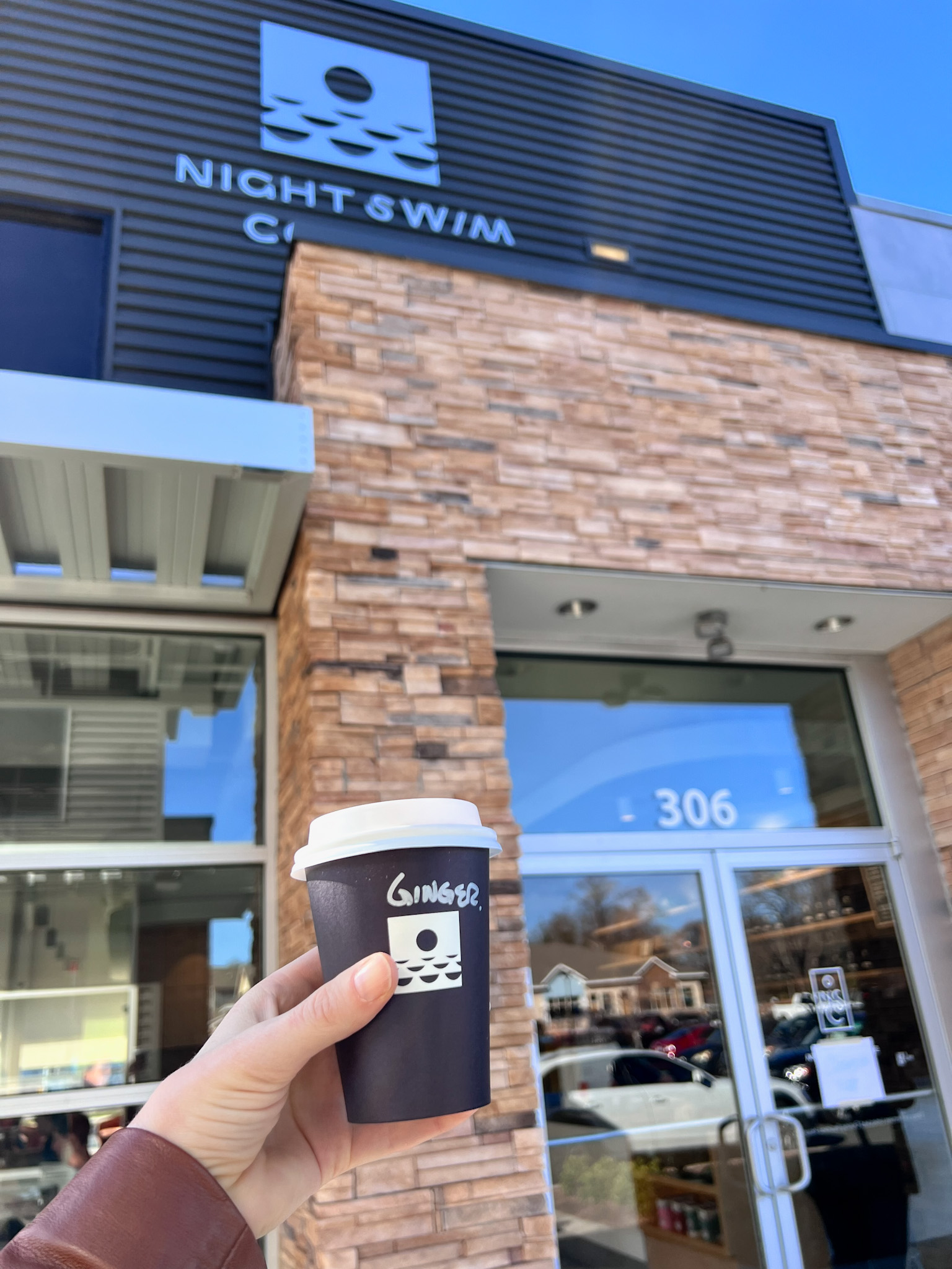 Alyssa holds a cup at Night Swim's Oakhurst location