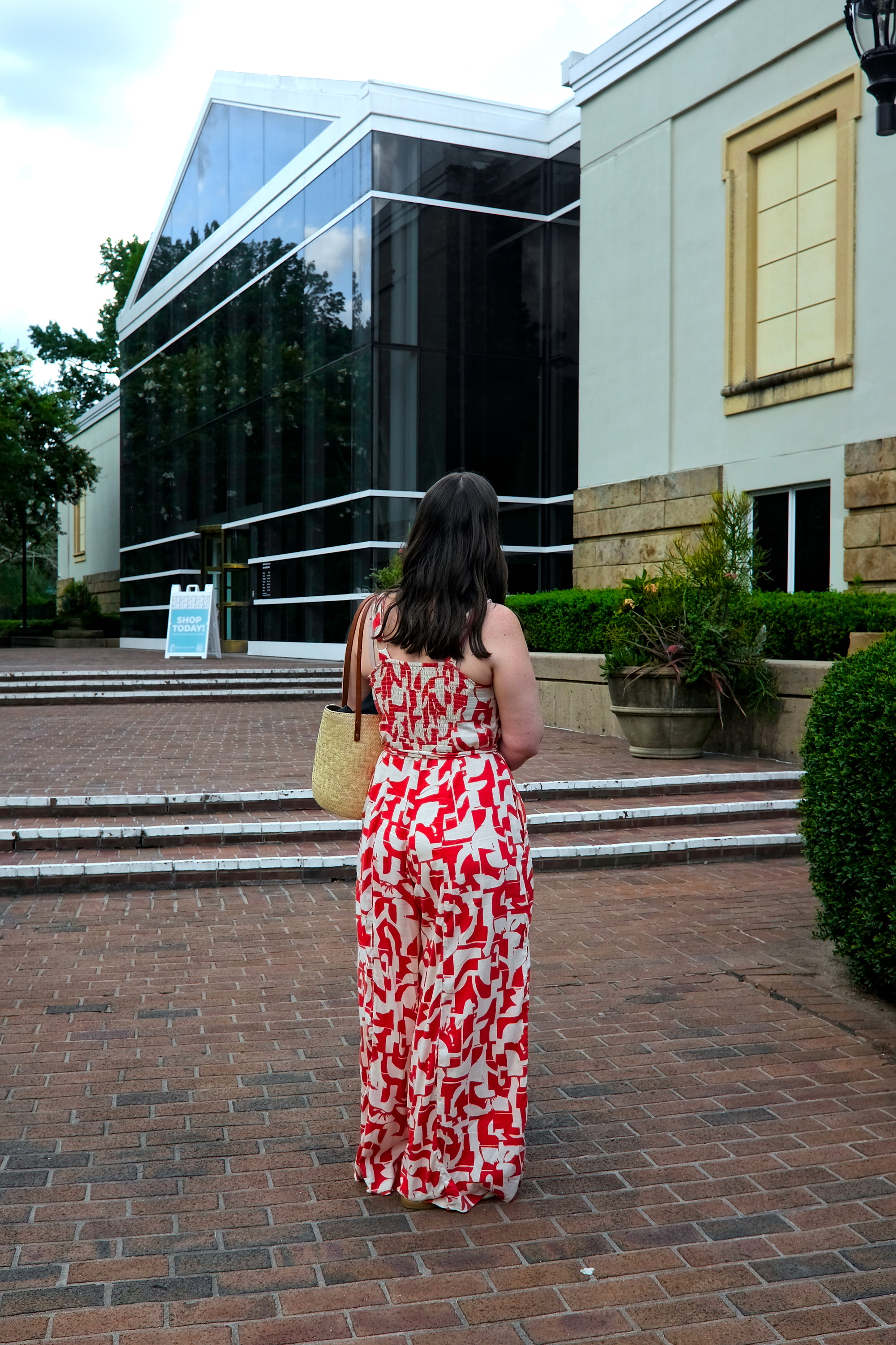 Alyssa wears the Promenade jumpsuit but is turned away from the camera