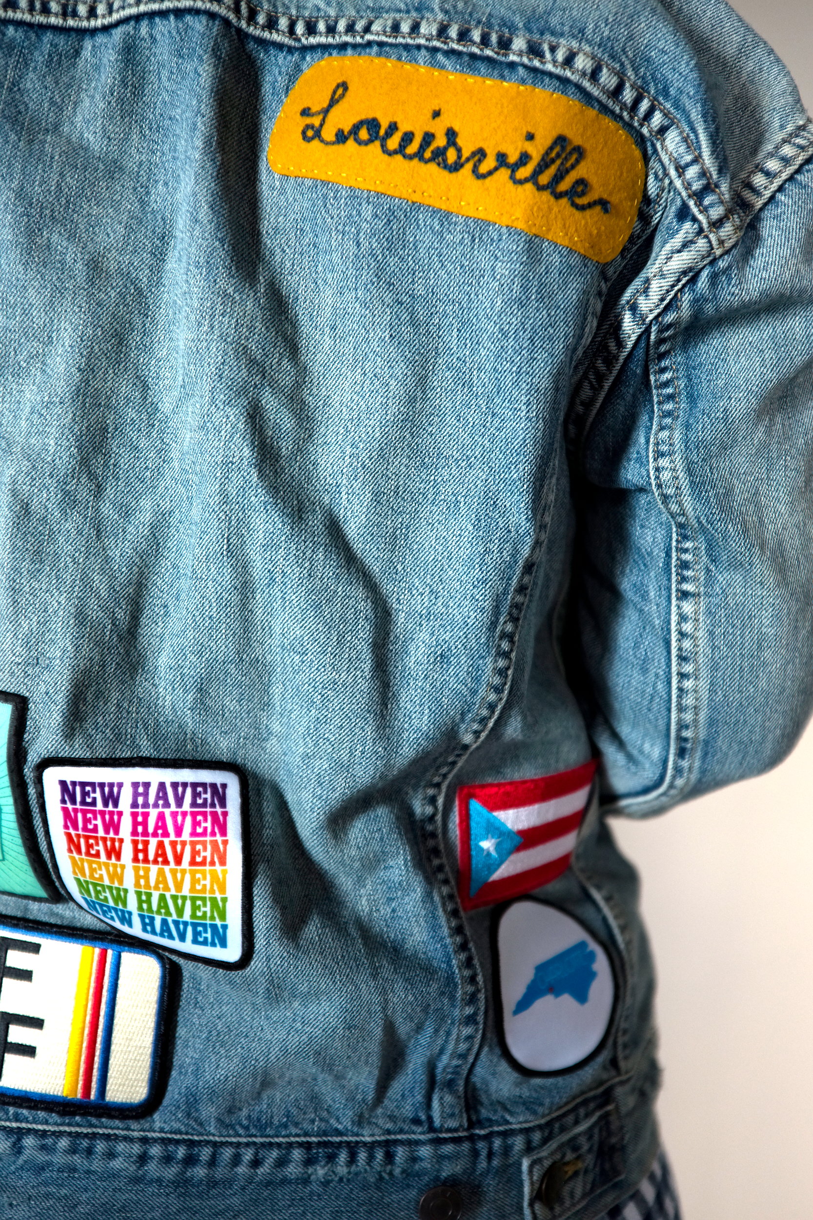 A close-up of Alyssa wearing a denim patch jacket