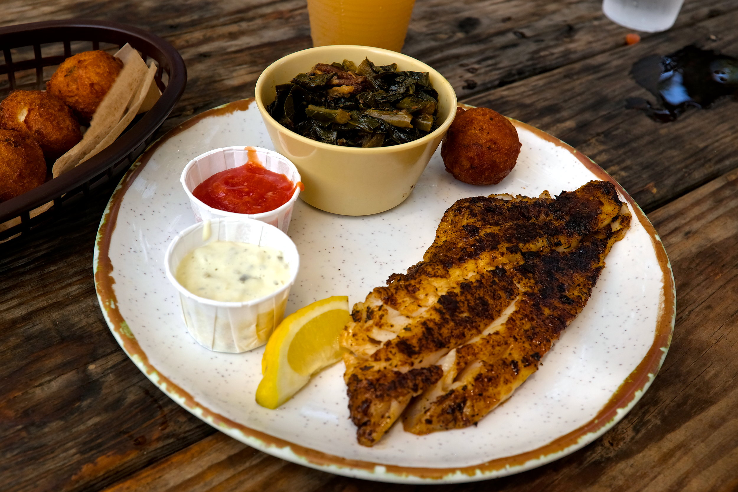 Blackened grouper with collards and hush puppies