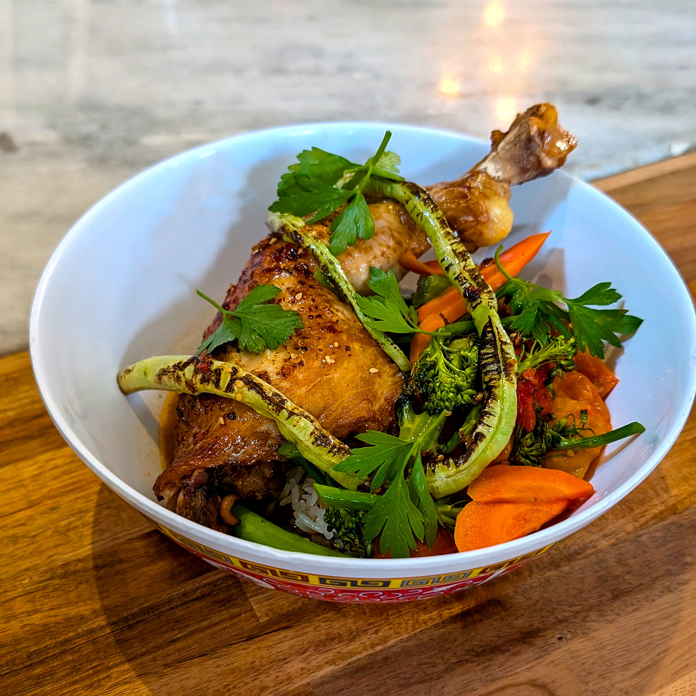 Chicken Adobo in a bowl with rice and veggies