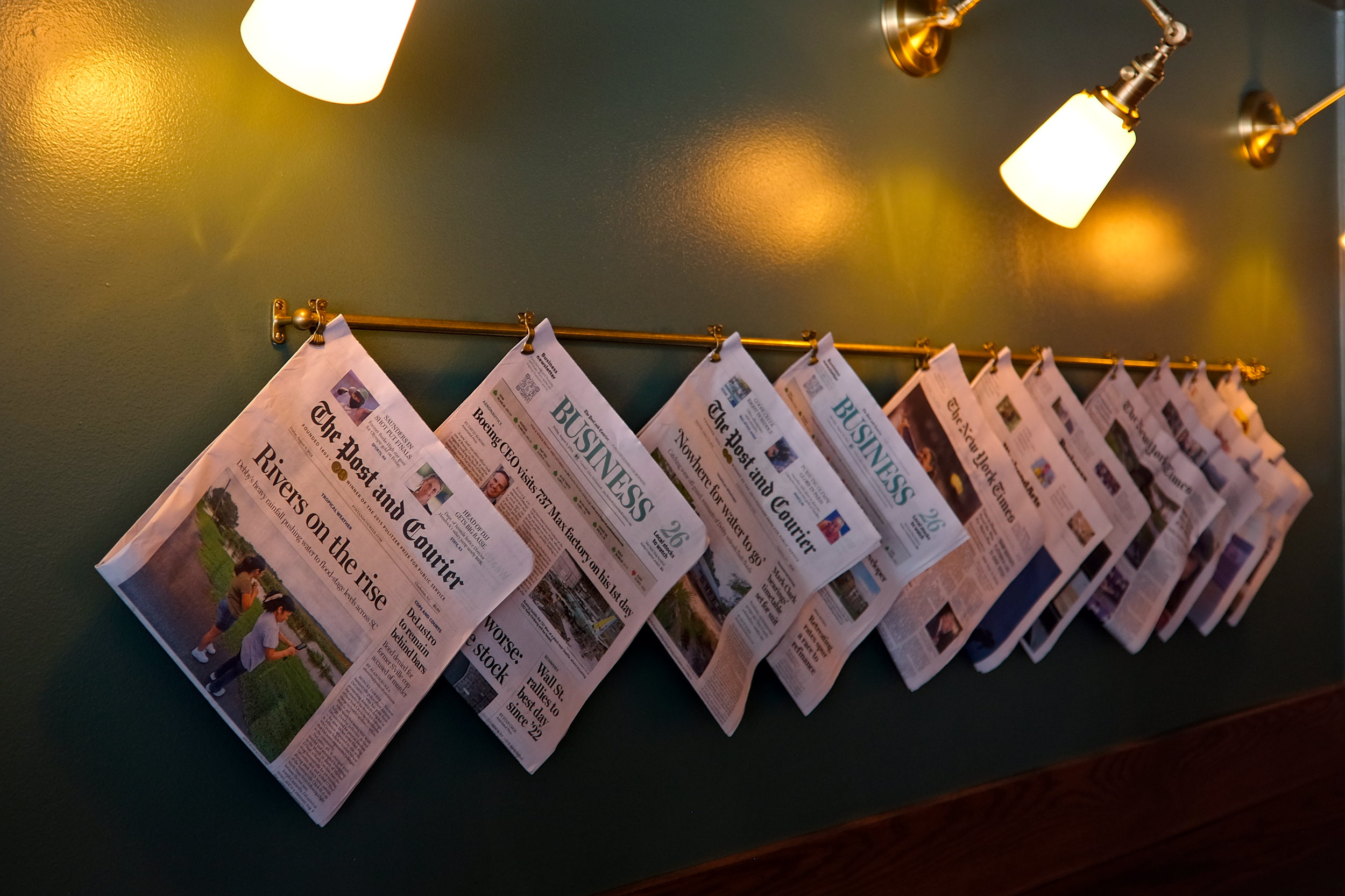 A line of papers on a rack at Porchetta Shop