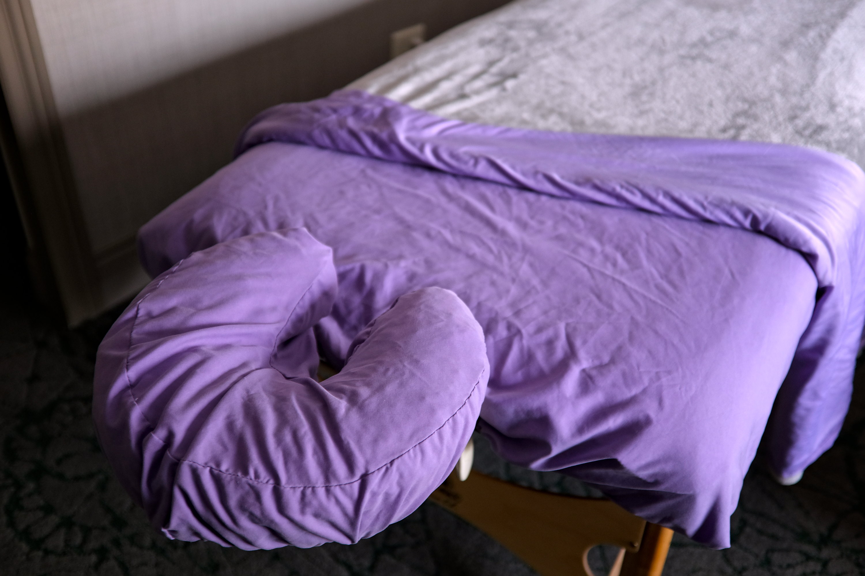 A massage table with a purple cover