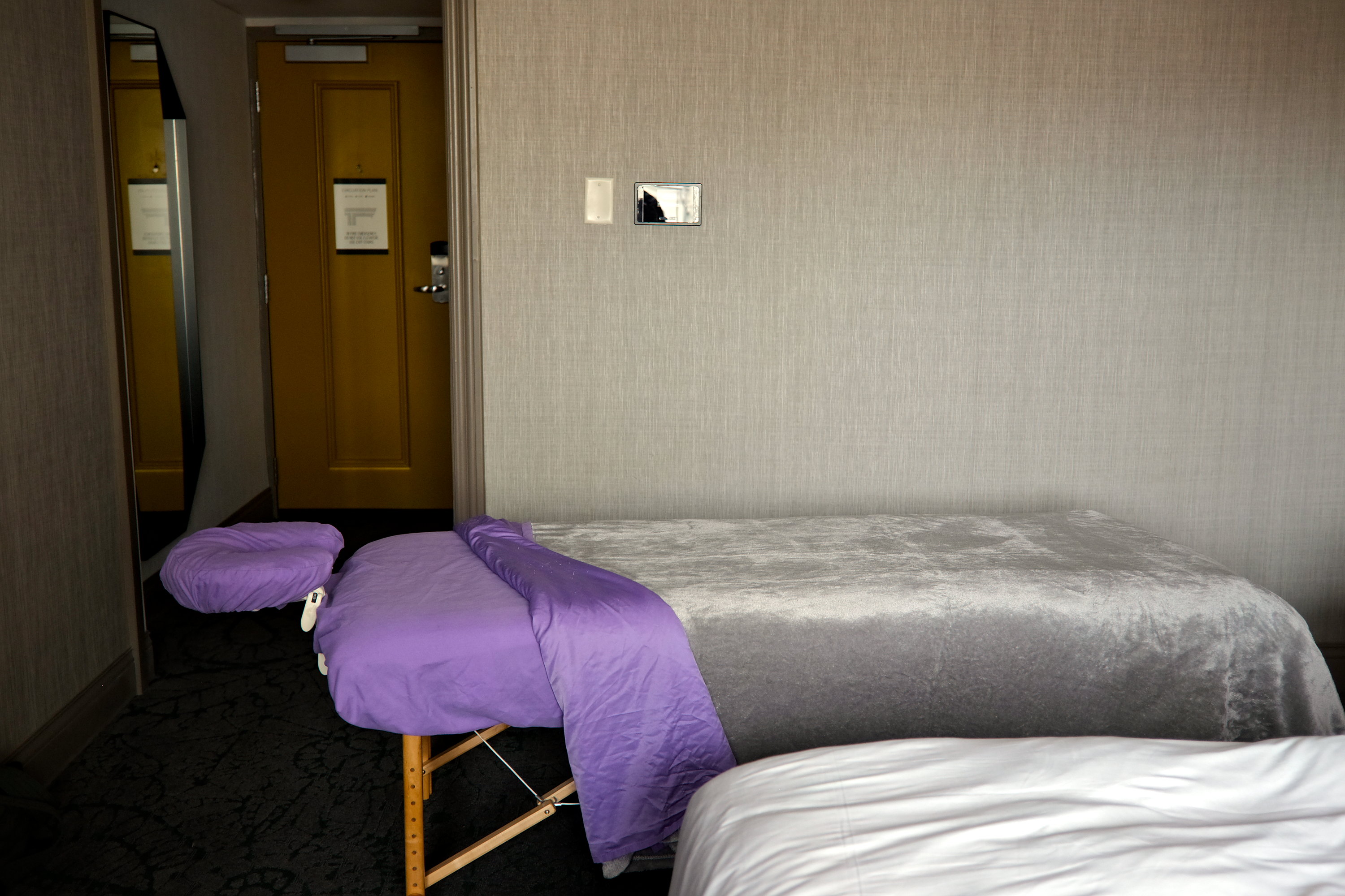 A massage table set up in a hotel room