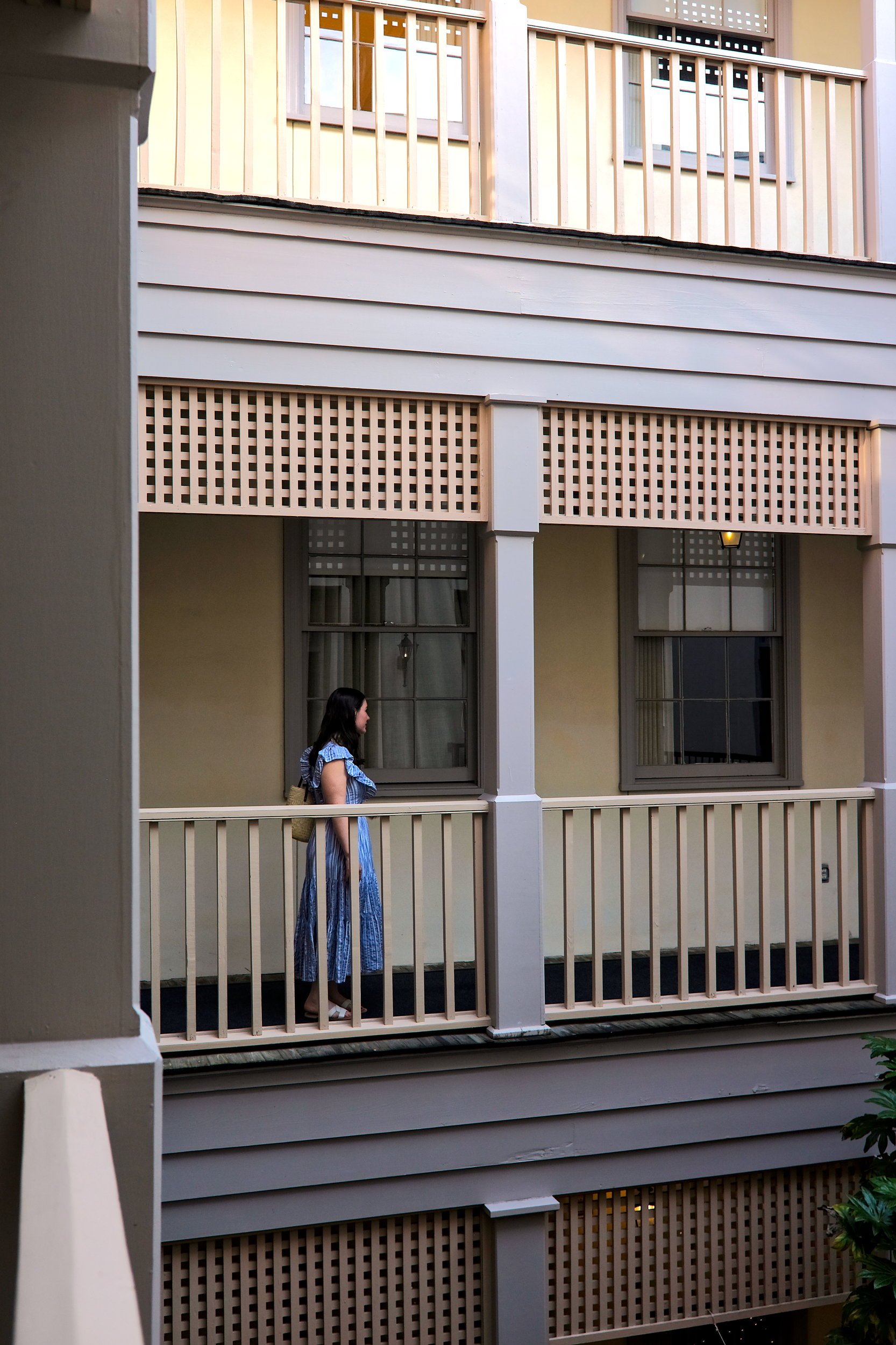 Alyssa walks along the balcony at Kings Courtyard Inn