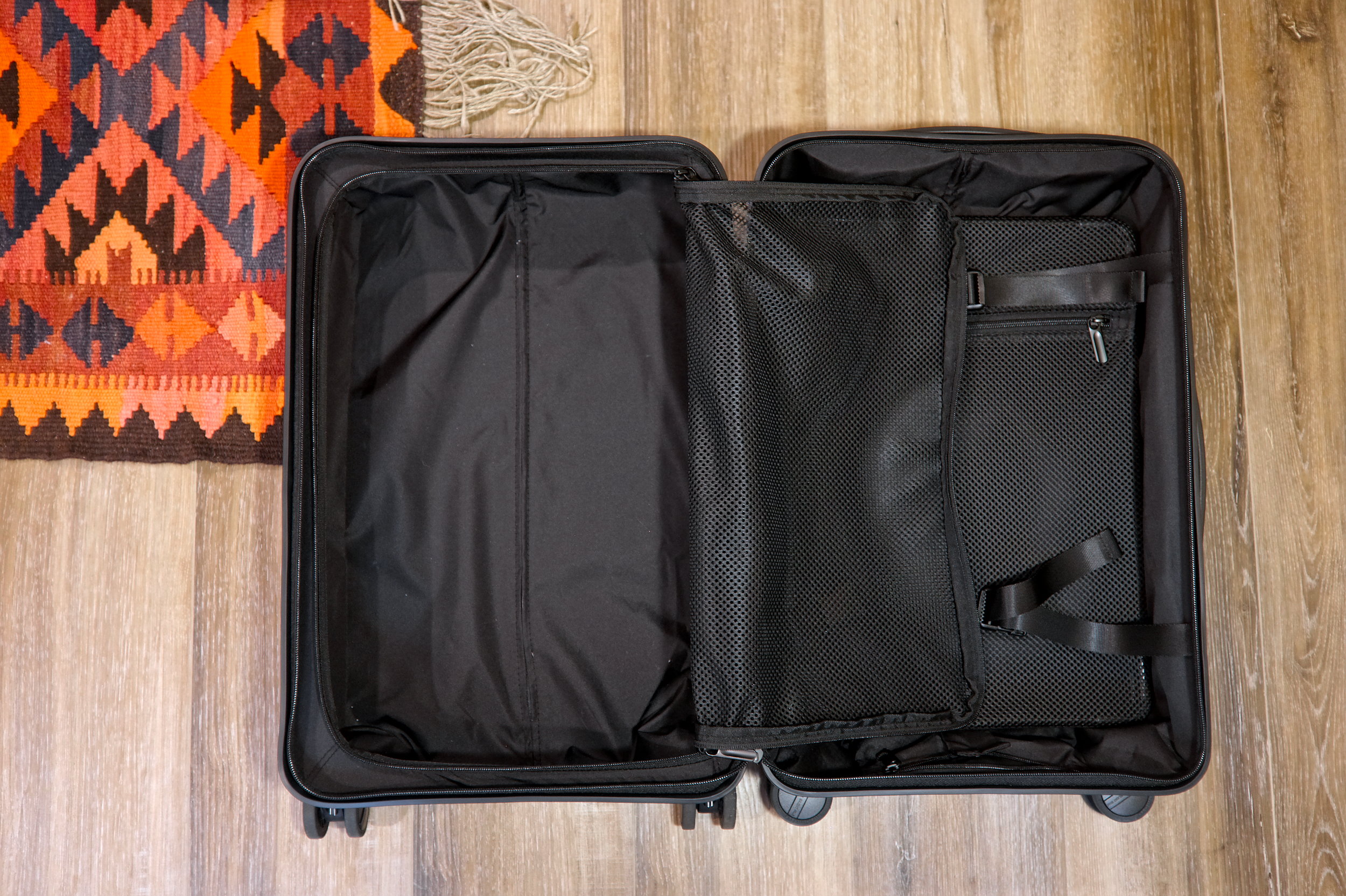 Interior of the Quince suitcase with the zippered half opened