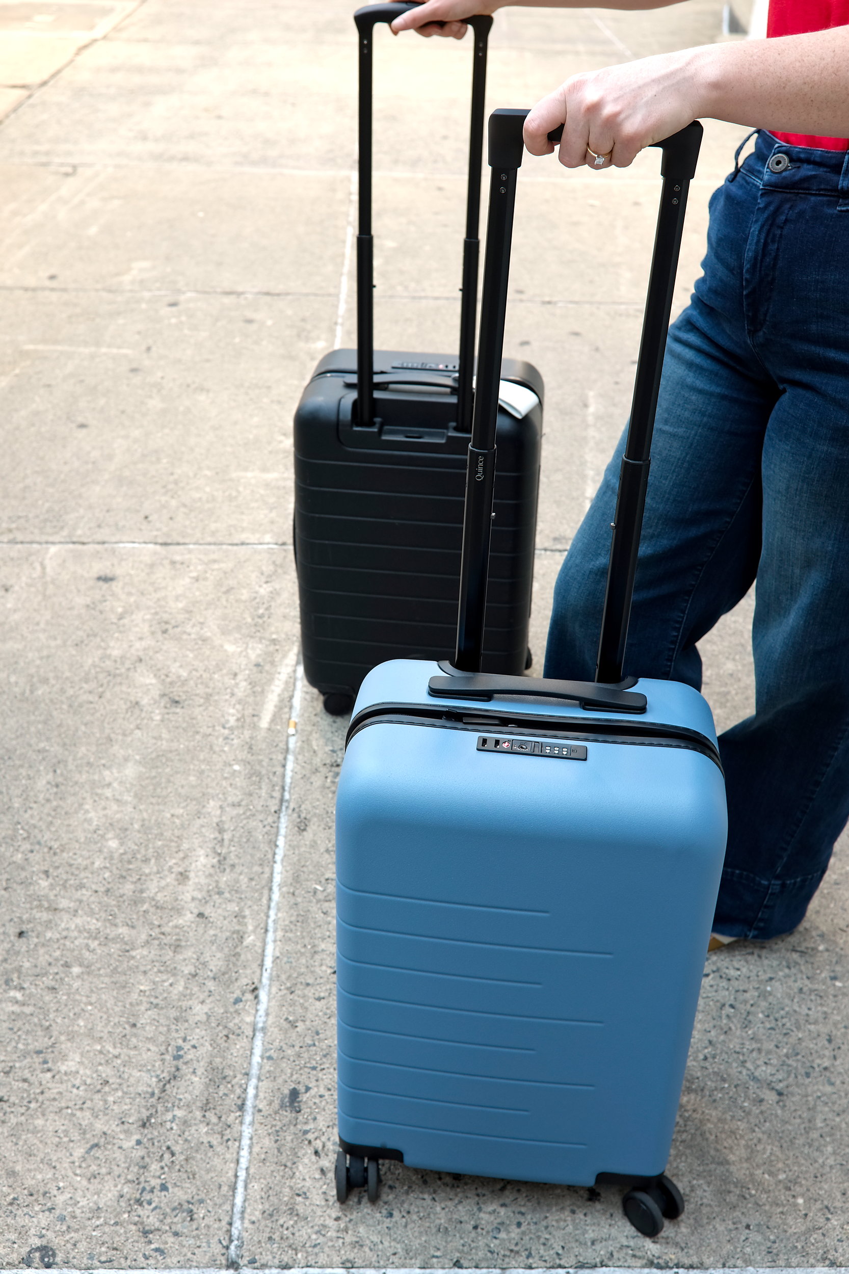 Alyssa rolls the Quince and Away Carry-On suitcases down a sidewalk in Charlotte
