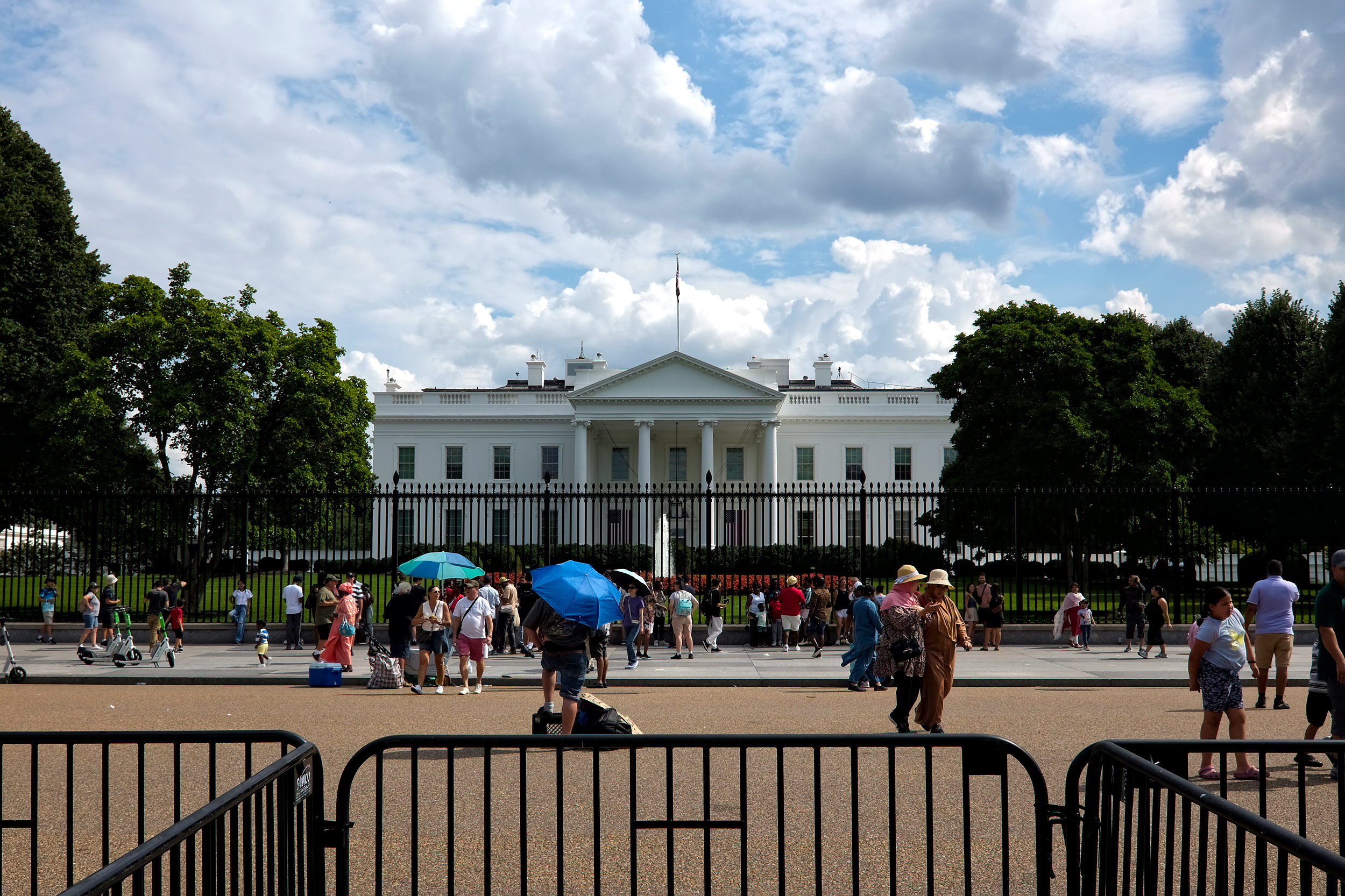 People mill in front of the White House