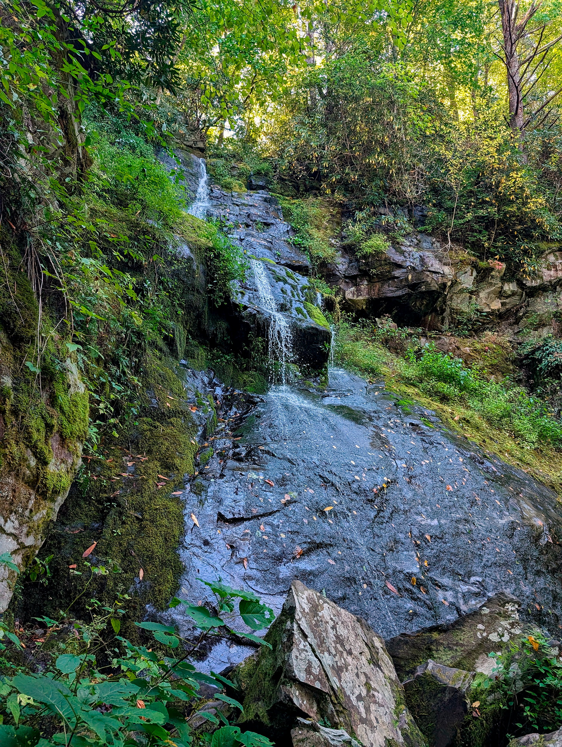 A steep waterfall with a slow trickle along the rock